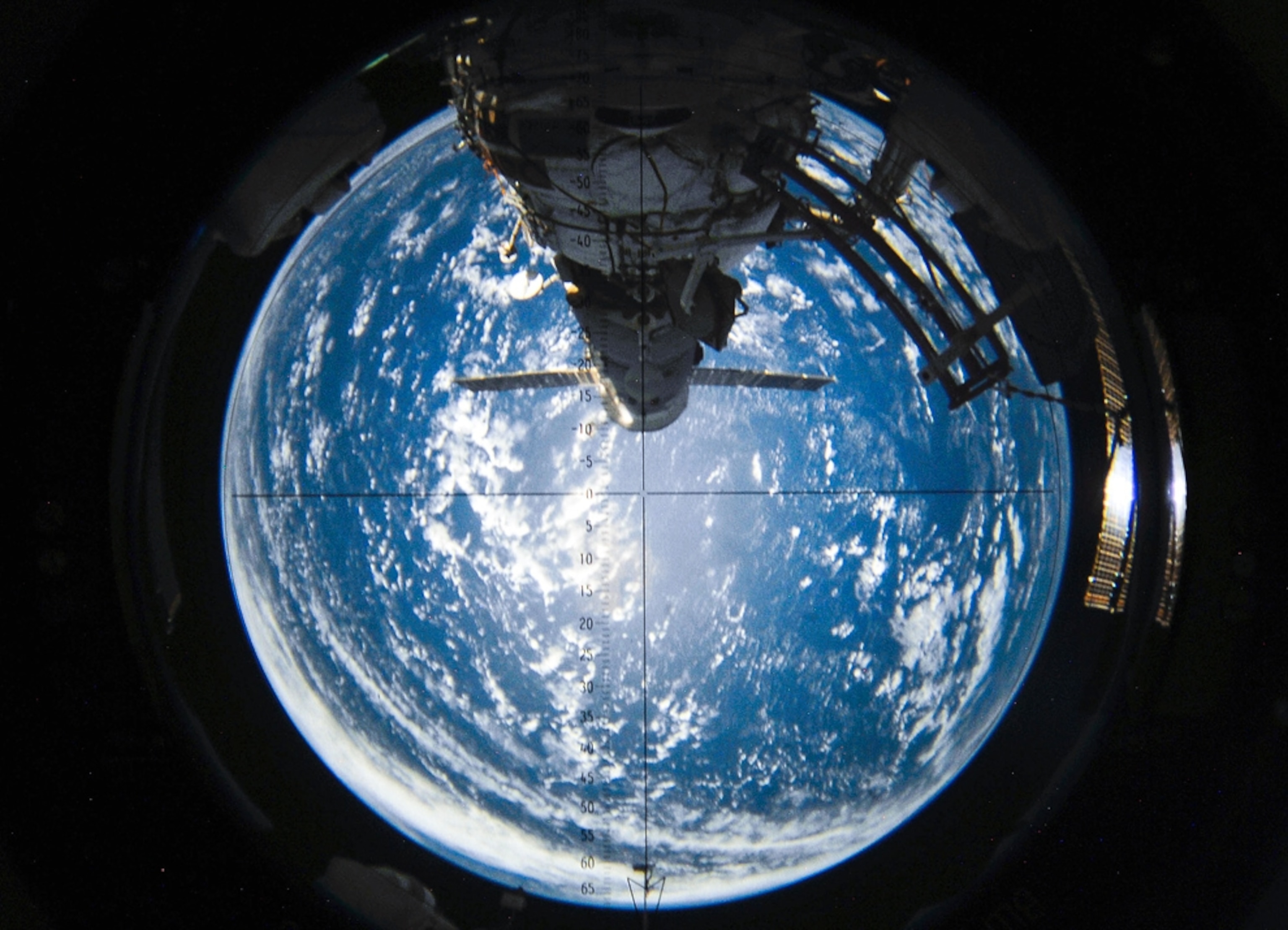 the aft section of the International Space Station with Earth in the background.