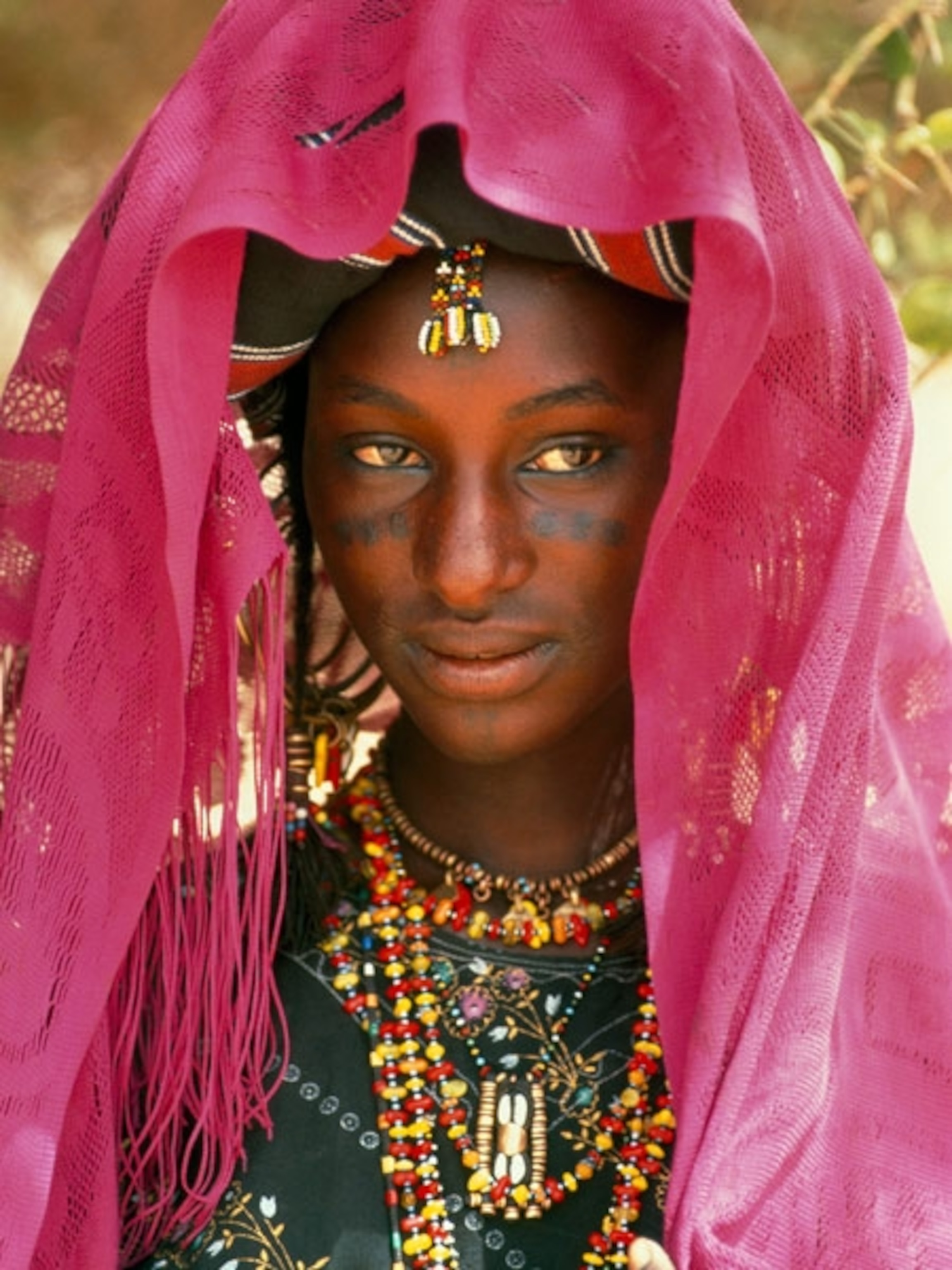 A woman wearing a veil and jewelry