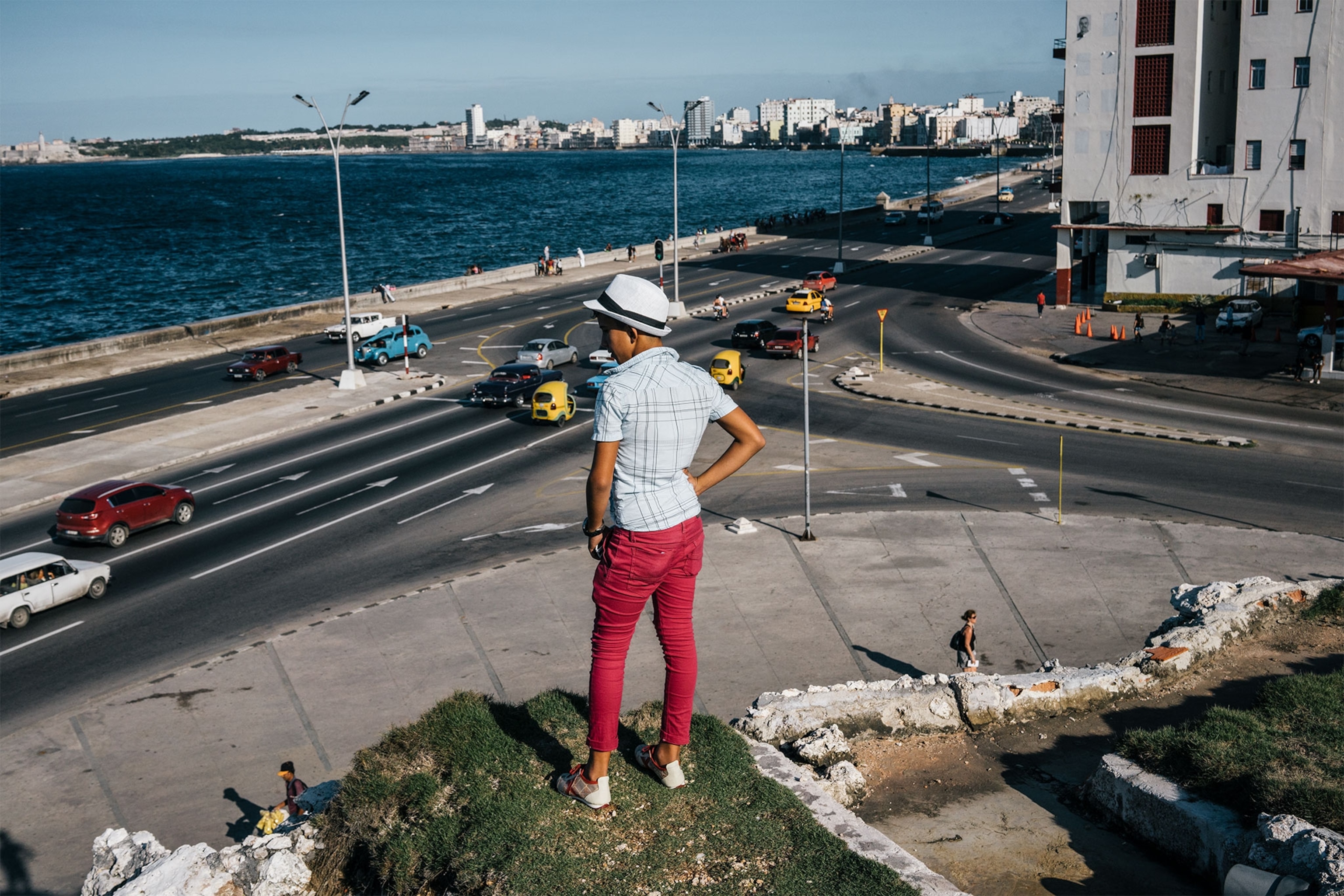 a boy looking out on the Malecón in Cuba