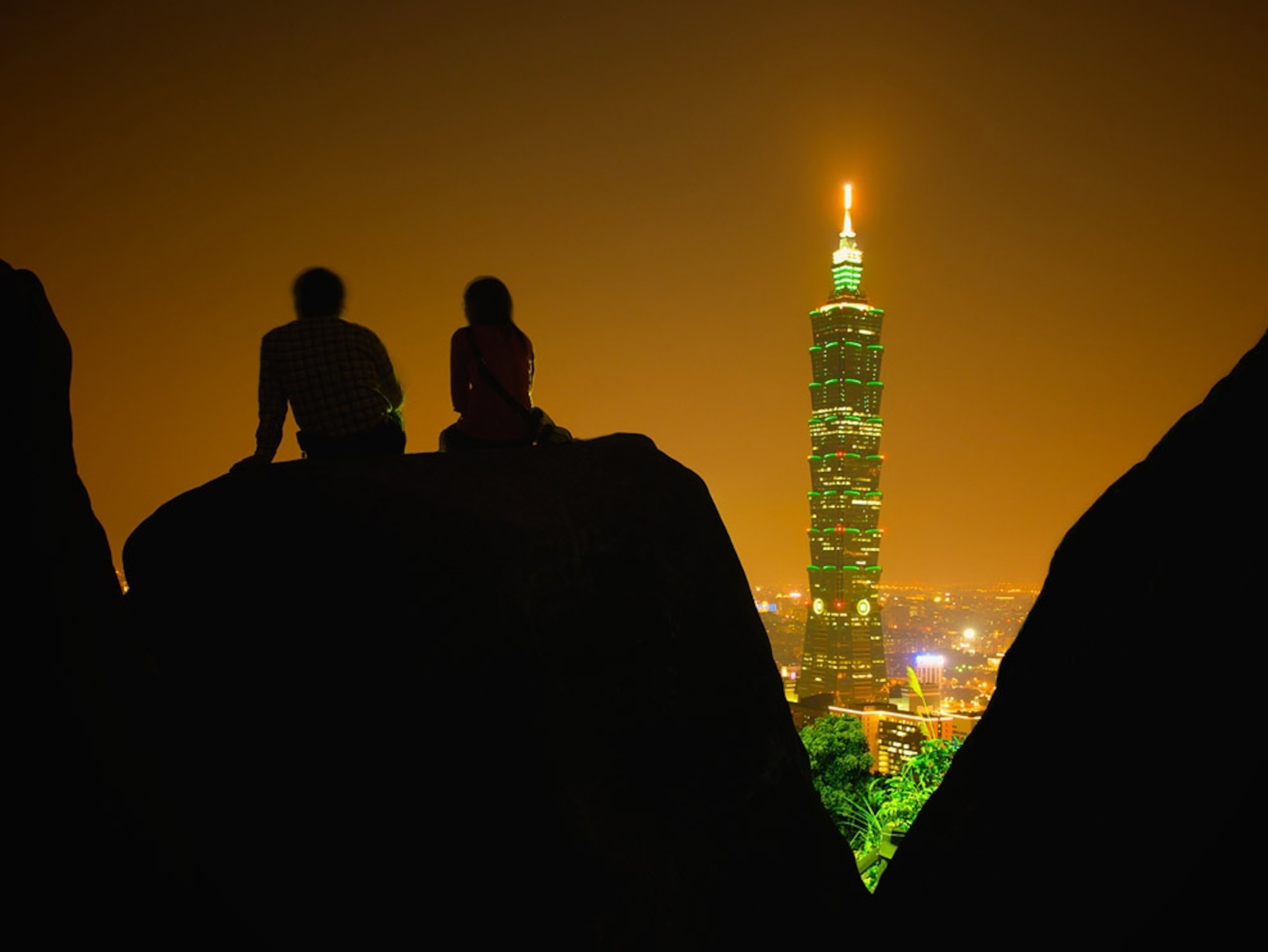 Brightly lit tall building at night