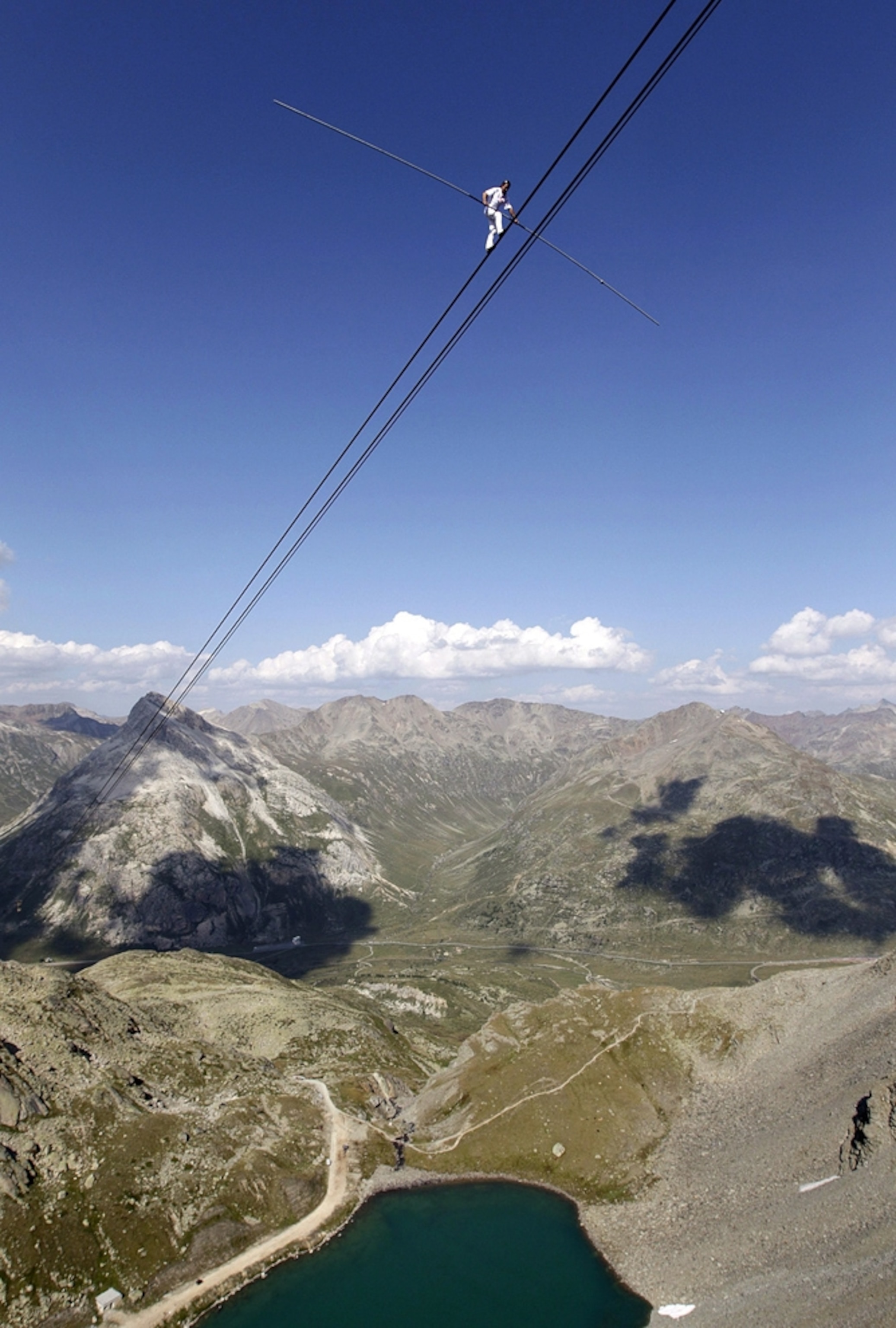 Tightrope walker picture: a man walks on a cable in Switzerland -- for best pictures of August photo gallery