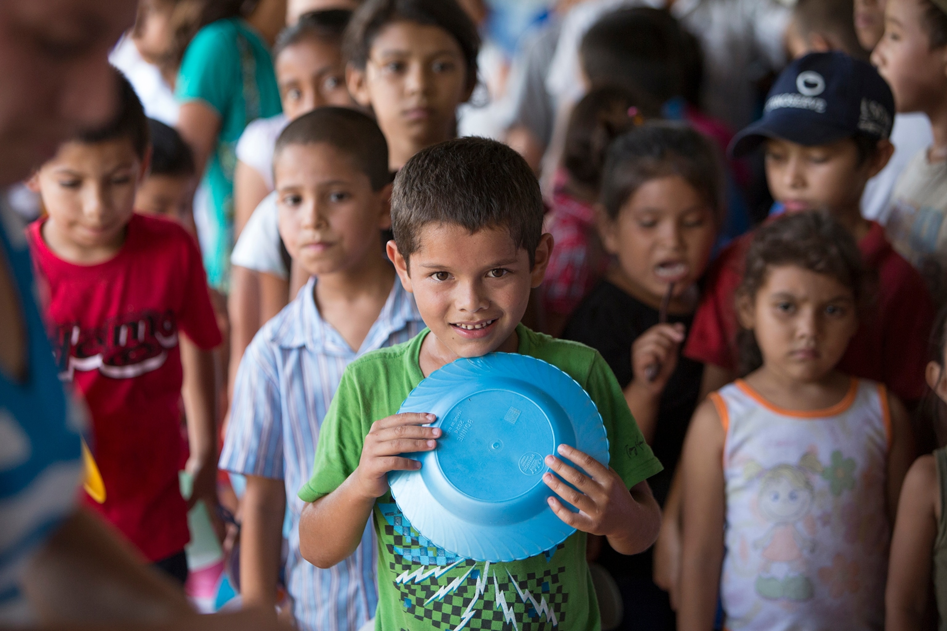 Students at the "El Progreso" school in Los Pedernales line up for their school meal provided by the United Nations World Food Programme (WFP).