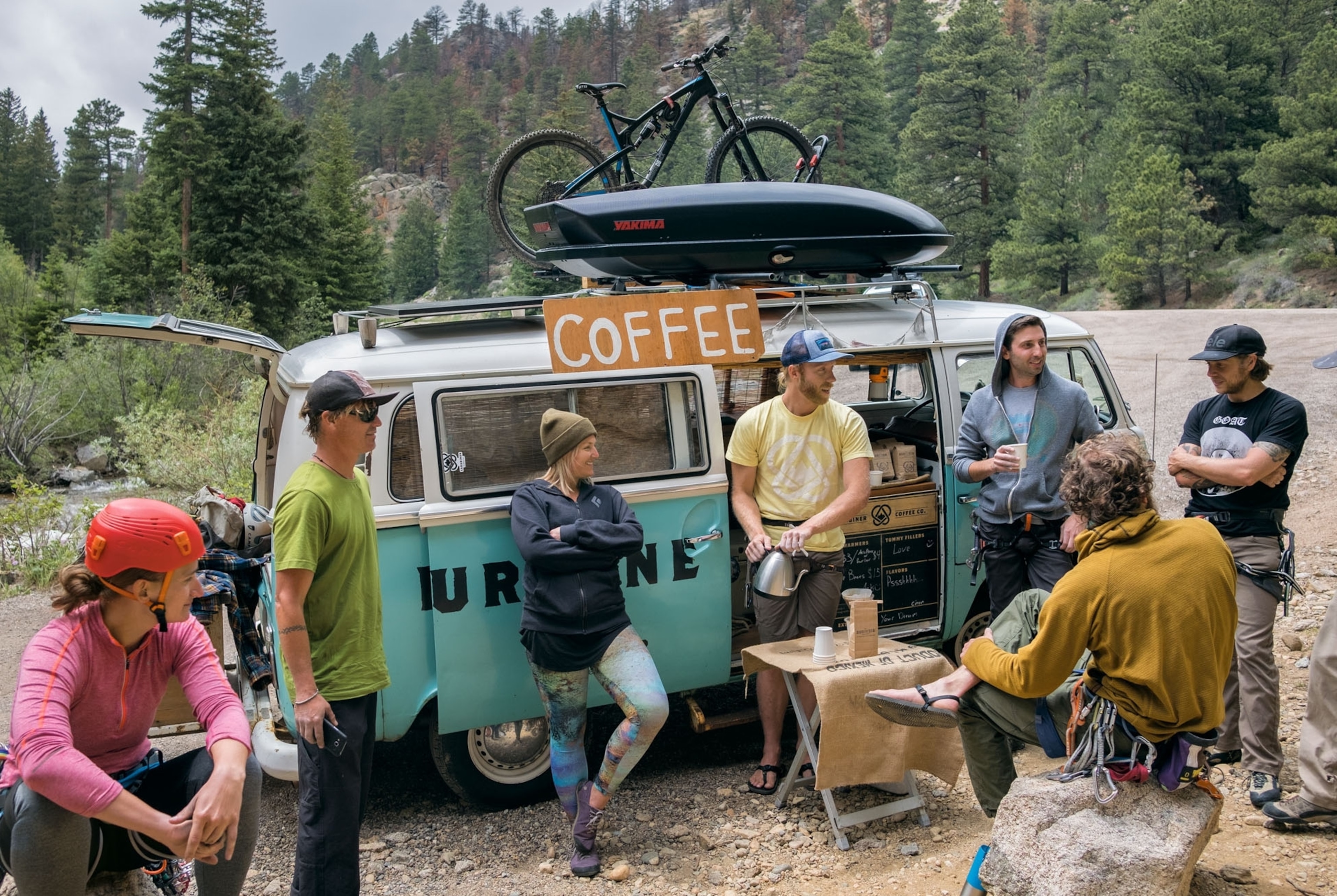 Carabiner Coffee owner serving climbers from vintage Volkswagen van, Colorado.