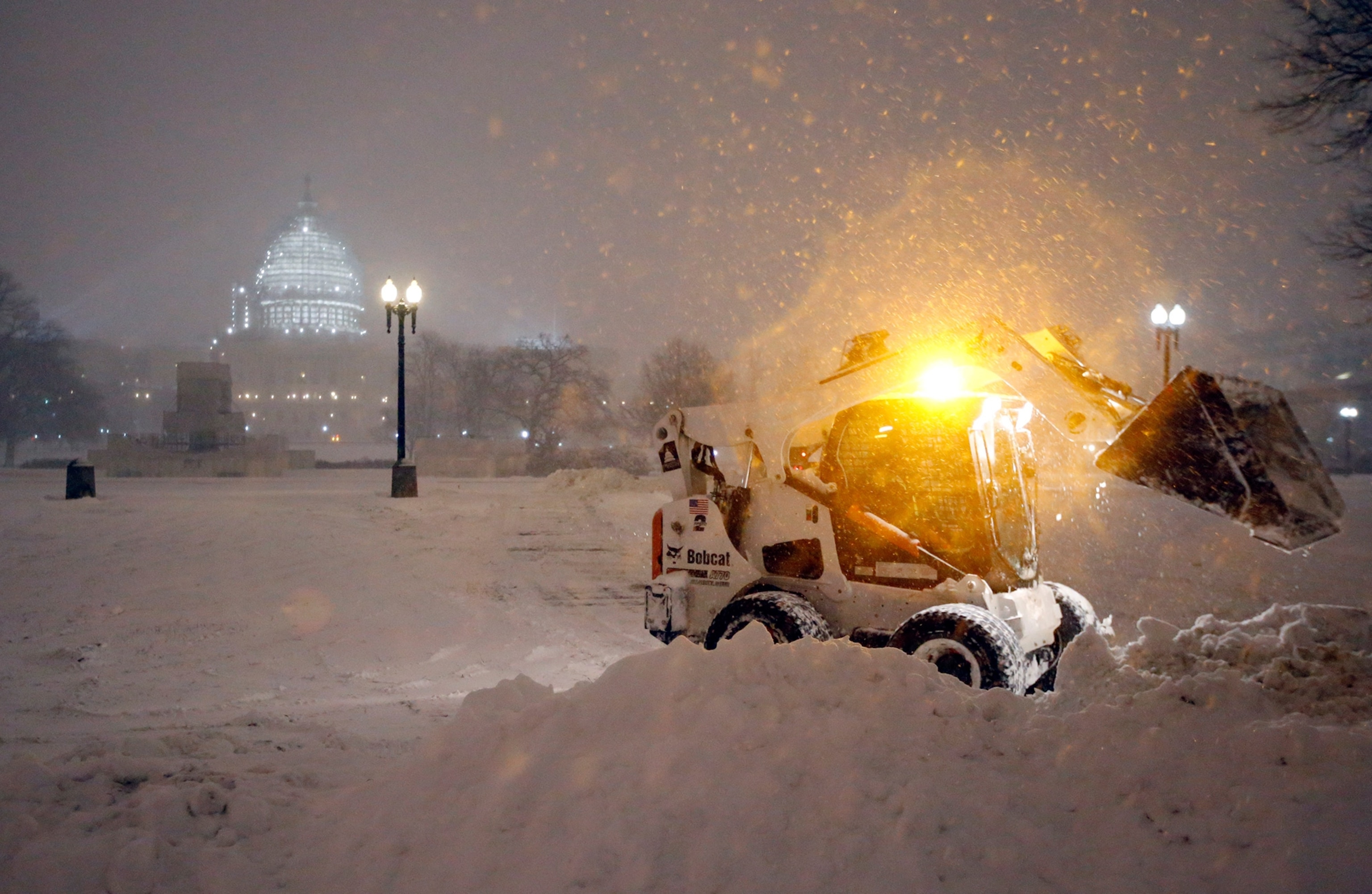 bobcat piles up snow in front of the U.S. Capitol