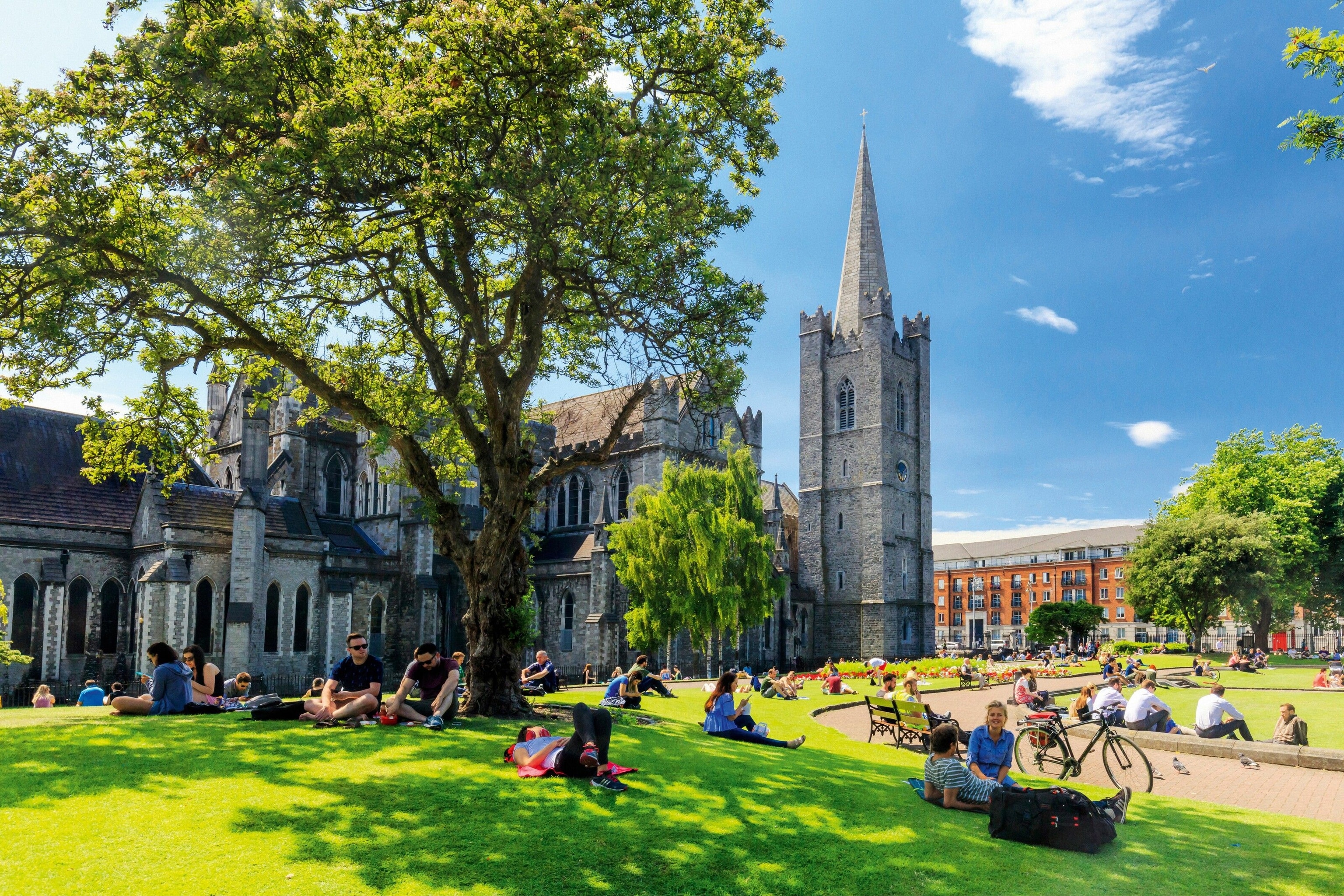 Dubliners enjoy the sunny lawns around St Patrick's Cathedral