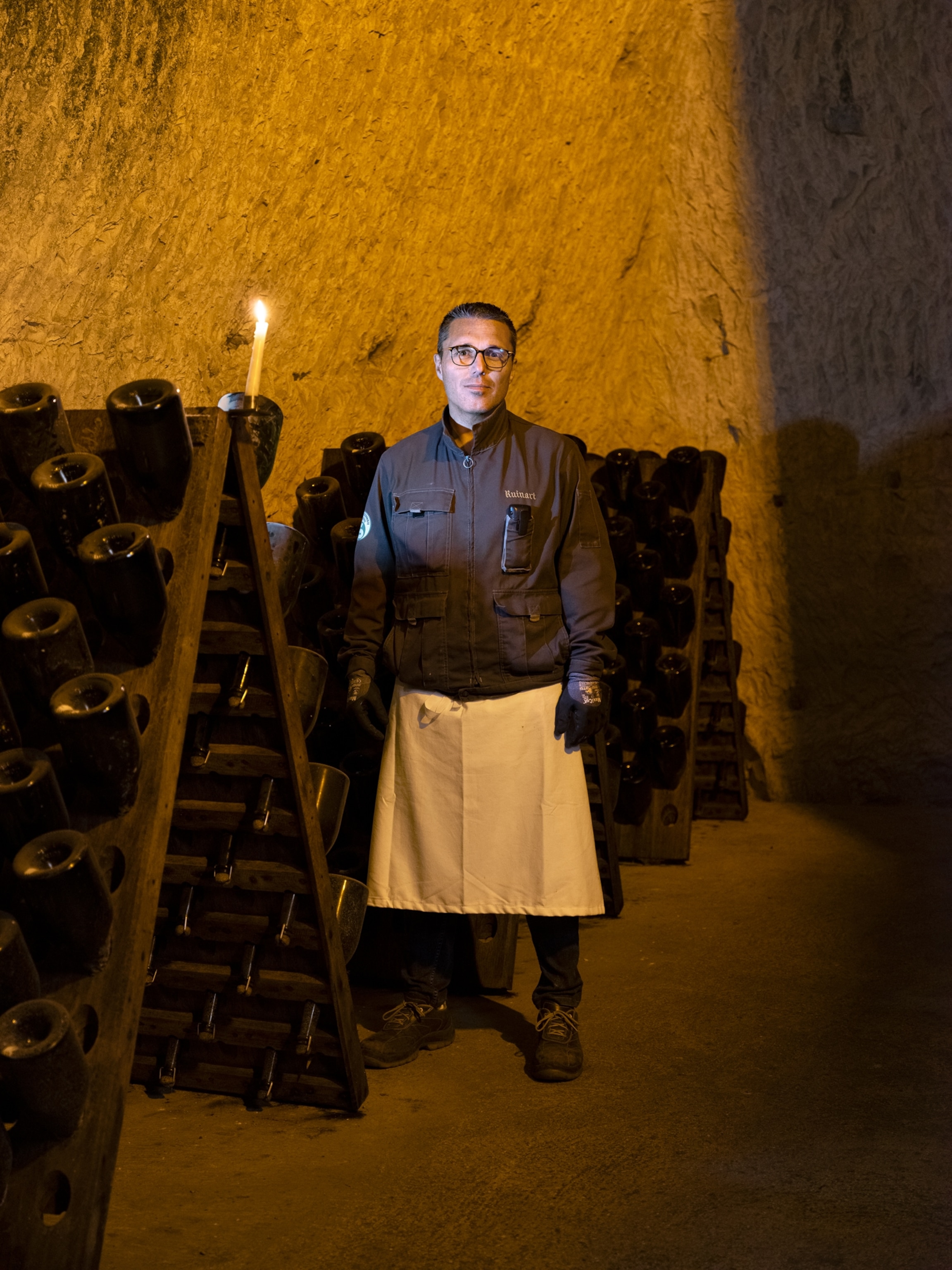 Portrait of Pablo Lopez, Champagne riddler and cellarman, standing in the crayères cellar at Ruinart, Reims, France.