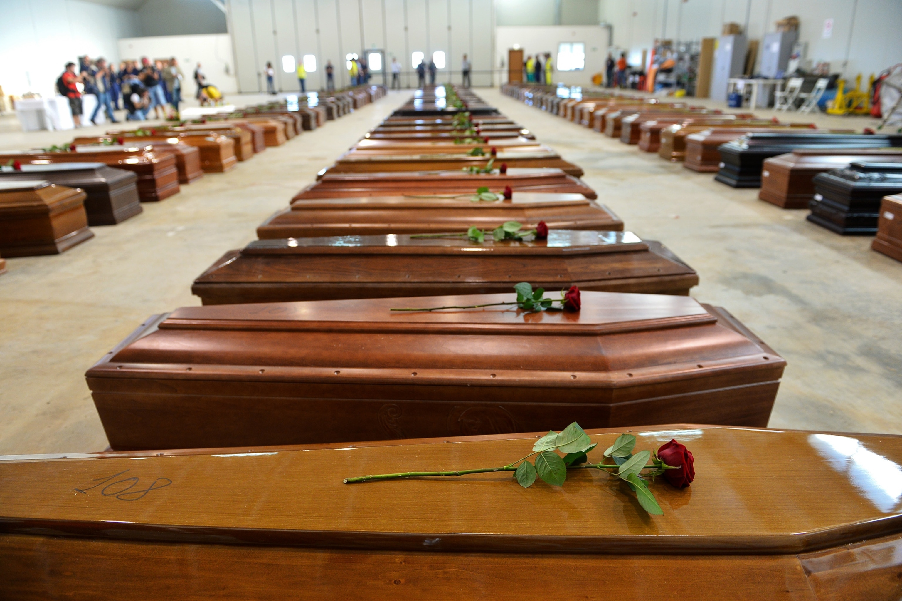 coffins of victims of a failed attempt to cross the Mediterranean.