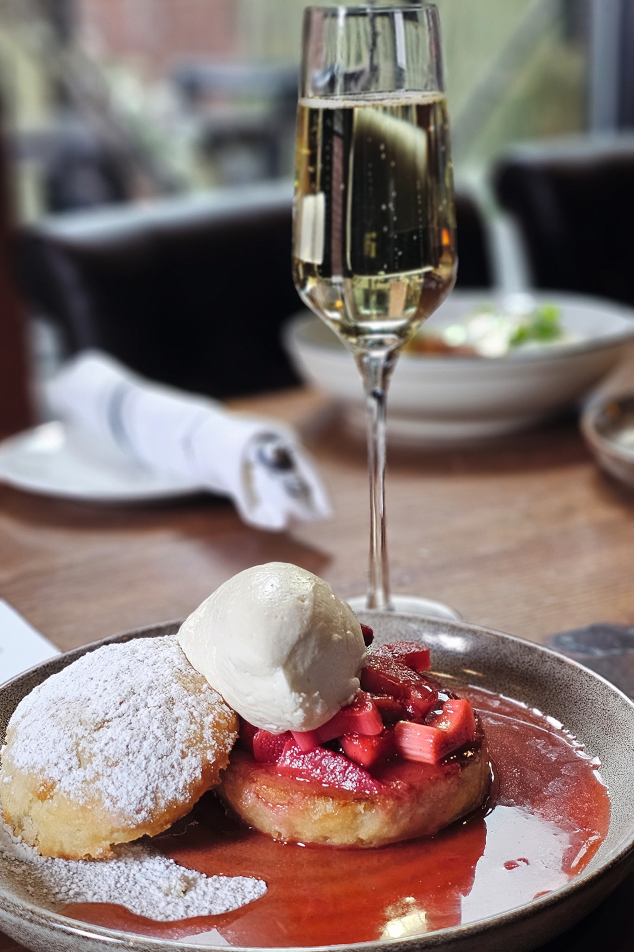 Dinner plate and champagne at Oak and Reed restaurant