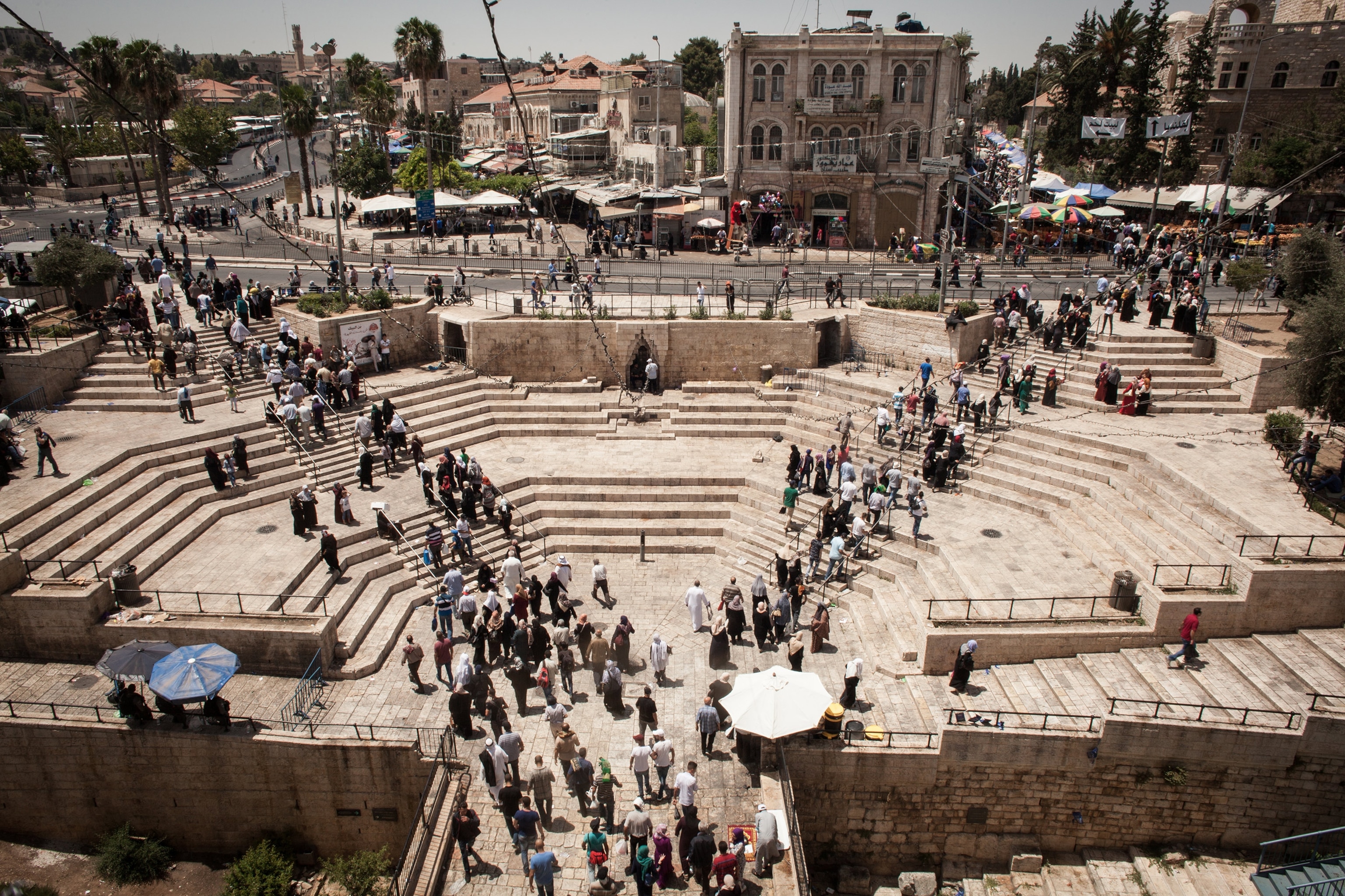 a crowd exiting the old city of Jerusalem through Damascus gate in Jerusalem, Israel