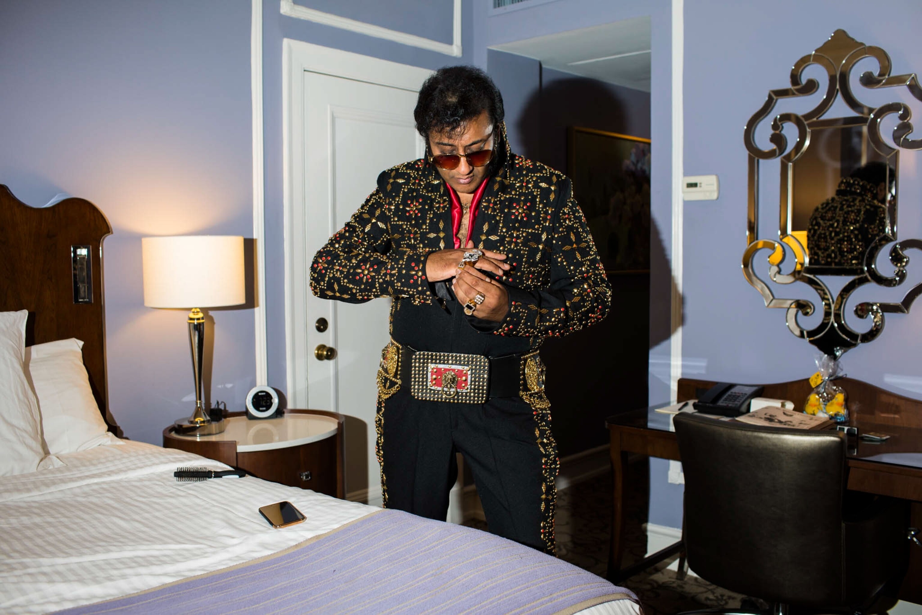 an Elvis tribute artist getting dressed