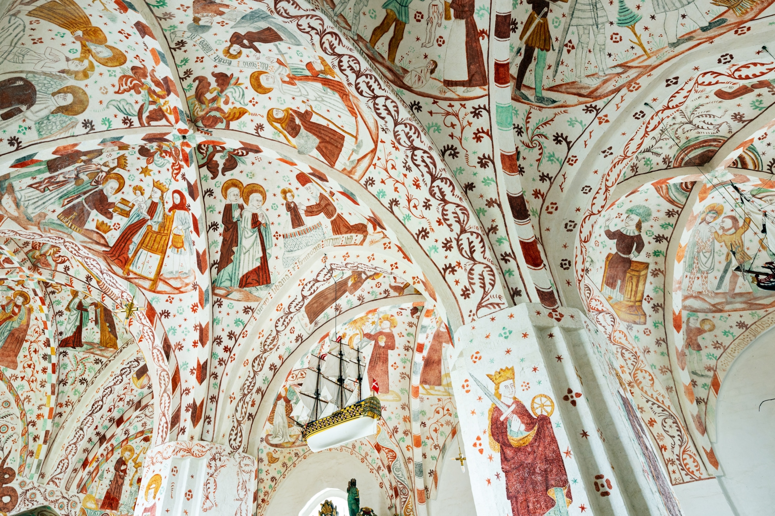 The vaulted ceiling of Fanefjord Church on the Danish island of Møn is covered with an extraordinary collection of medieval frescoes depicting biblical stories, religious figures and scenes from everyday life.
