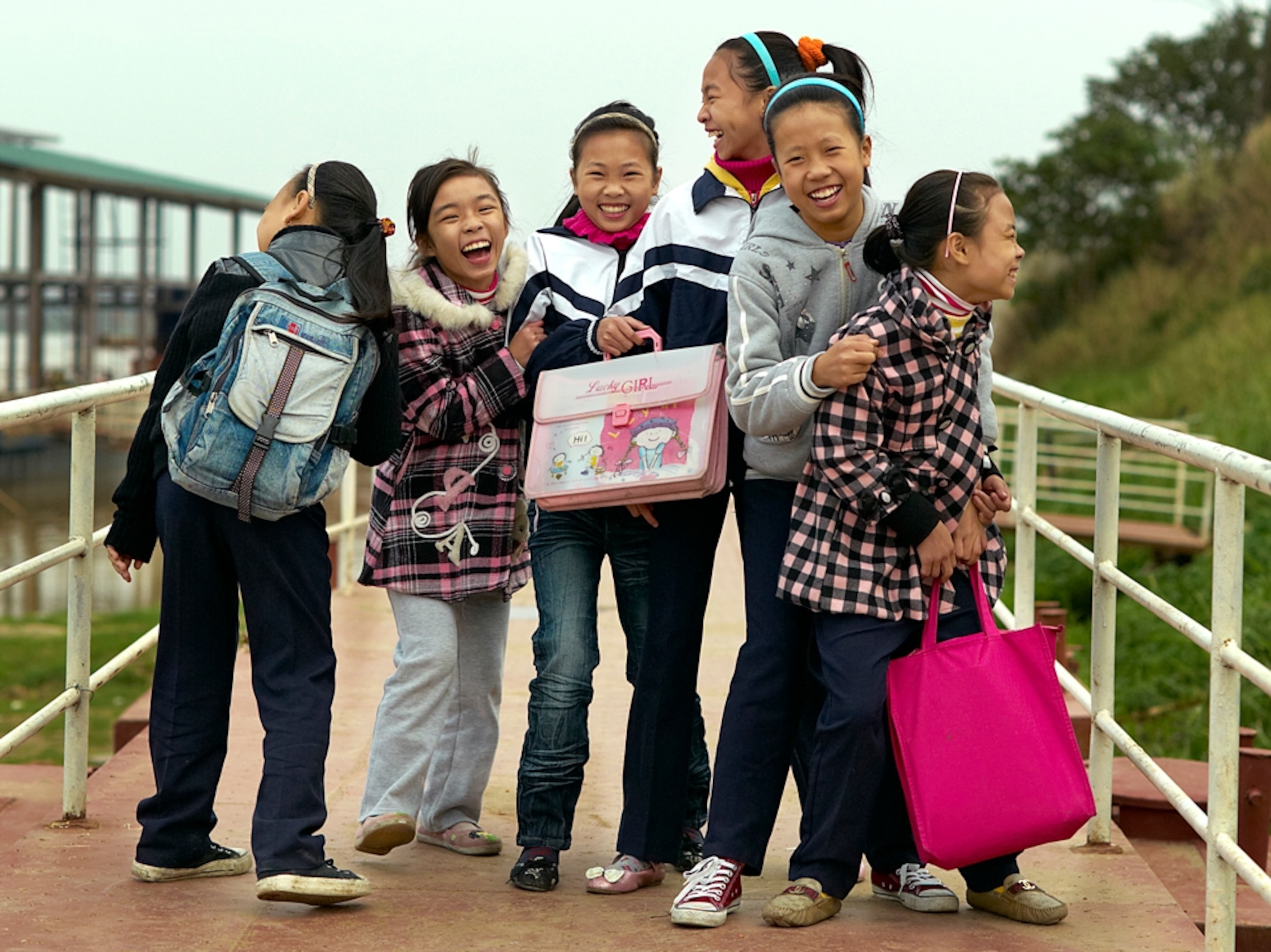 Laughing schoolgirls near river
