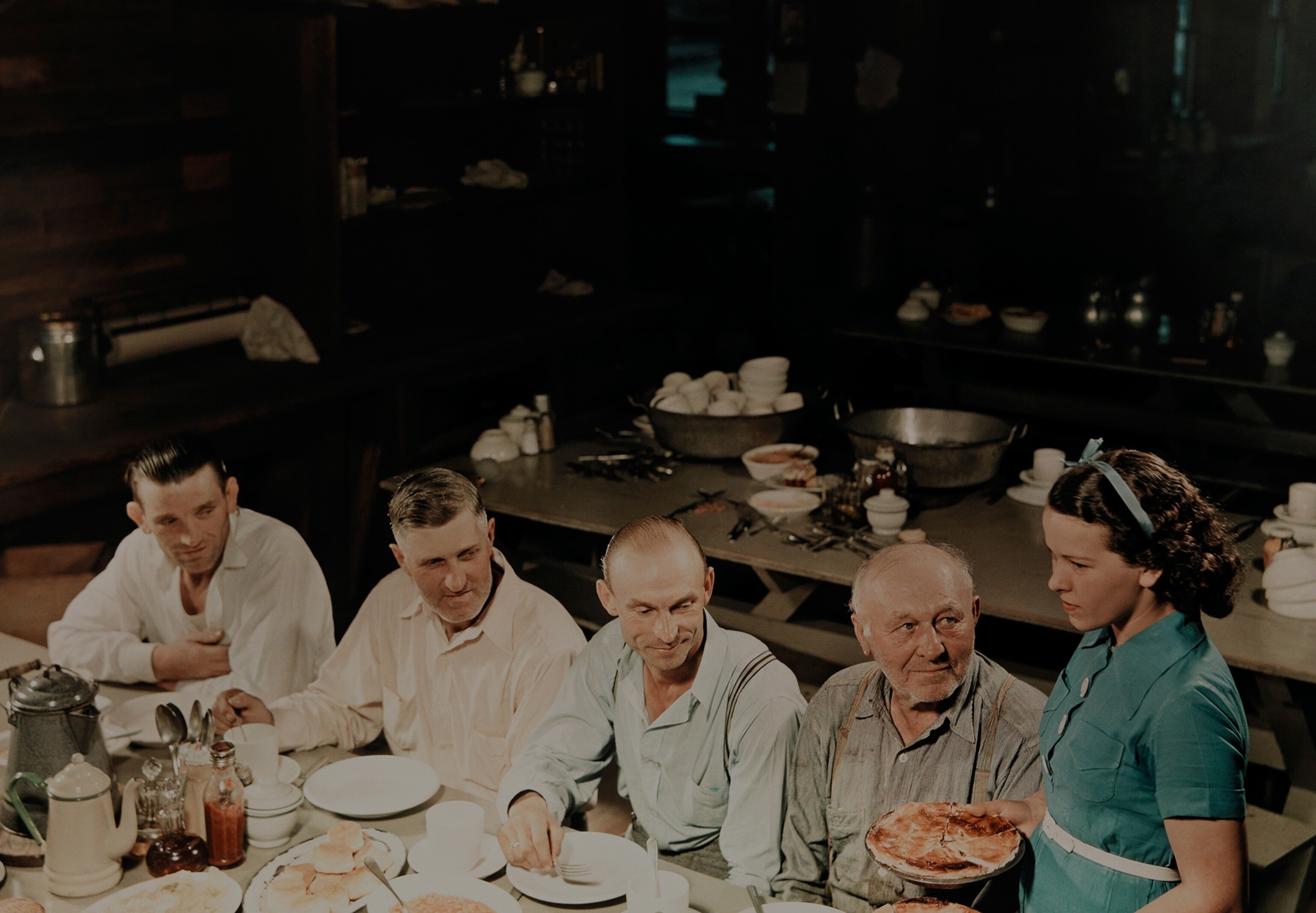 woman serving pie to lumbermen