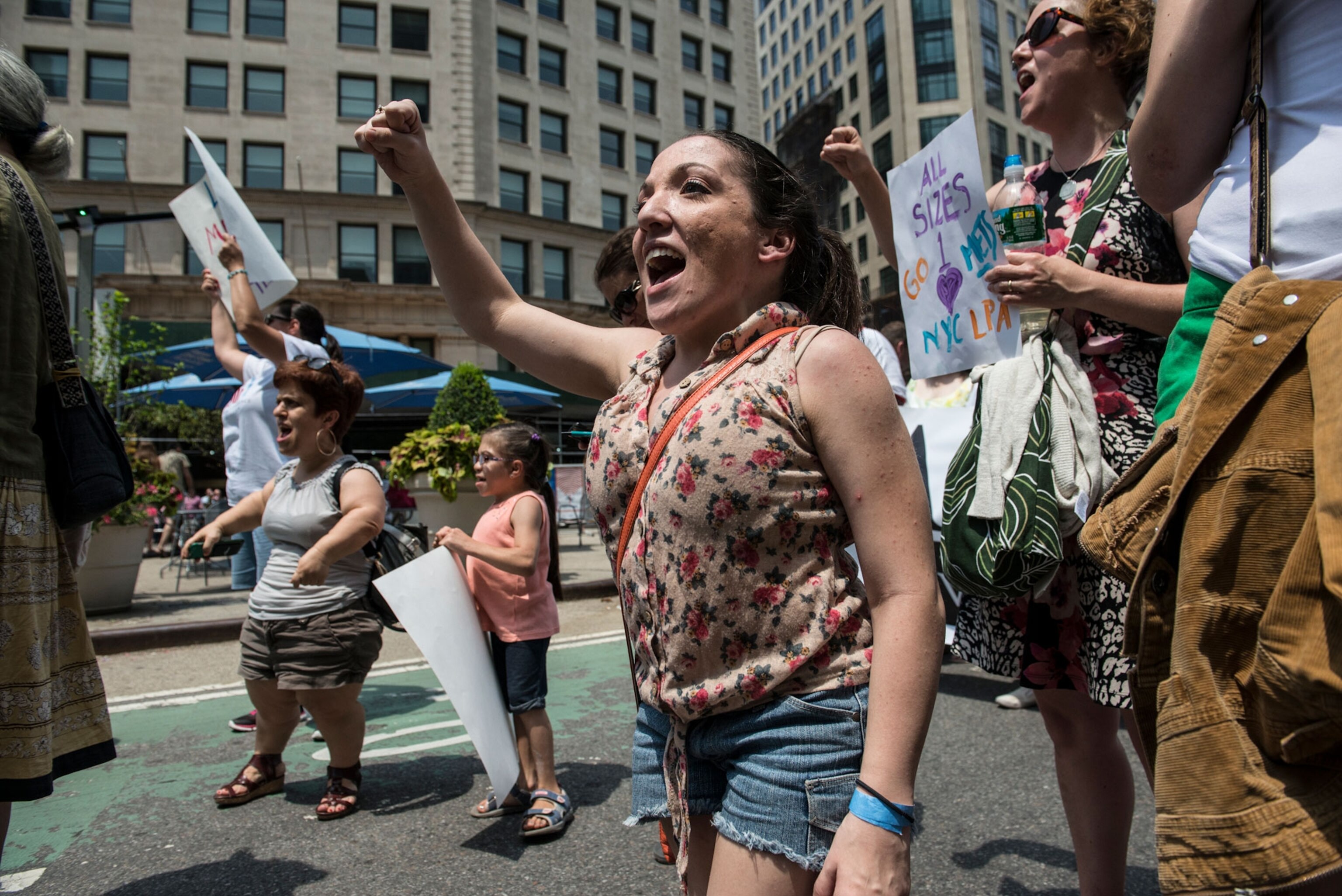a small person with their fist raised marching