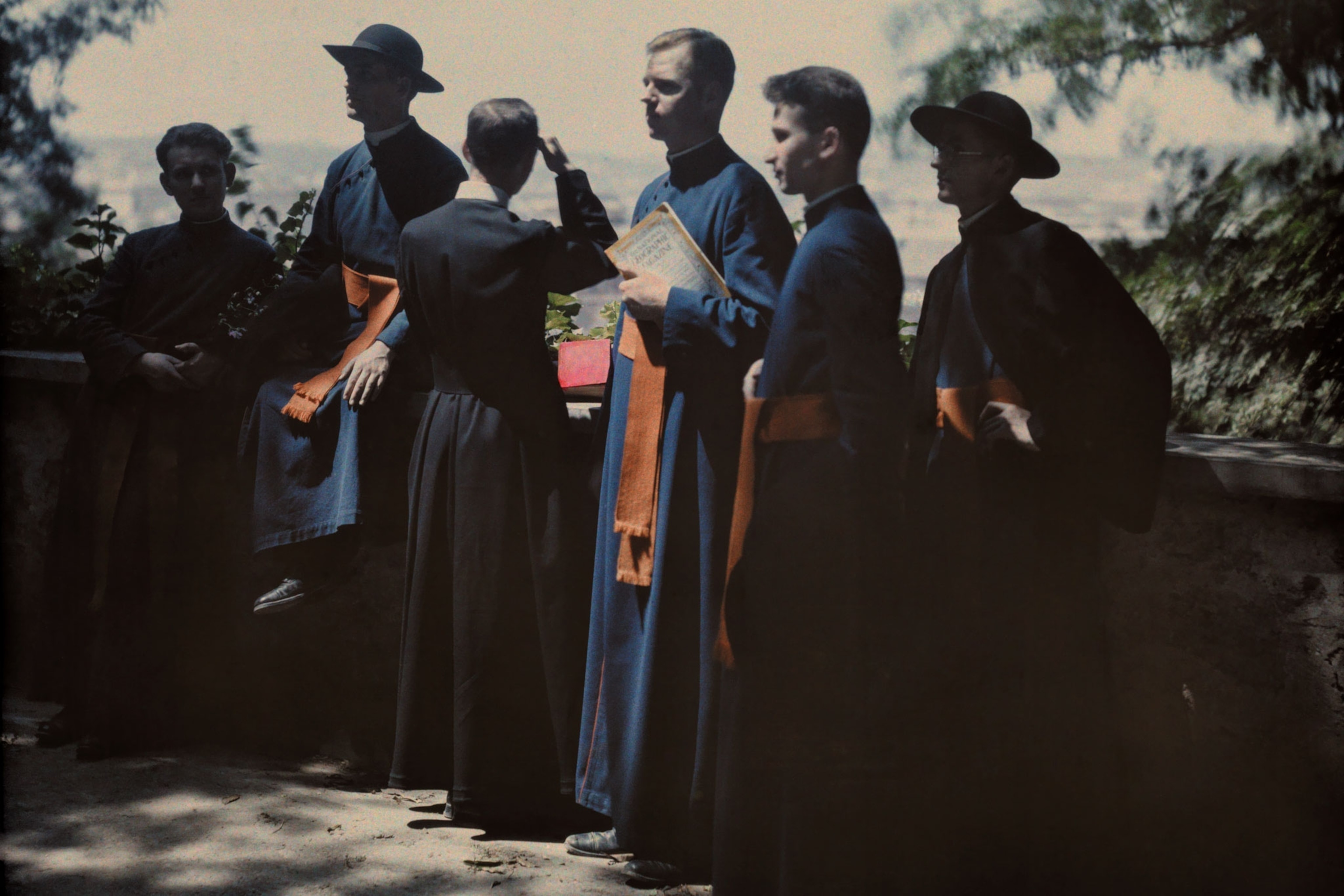 clergy holding a National Geographic Magazine