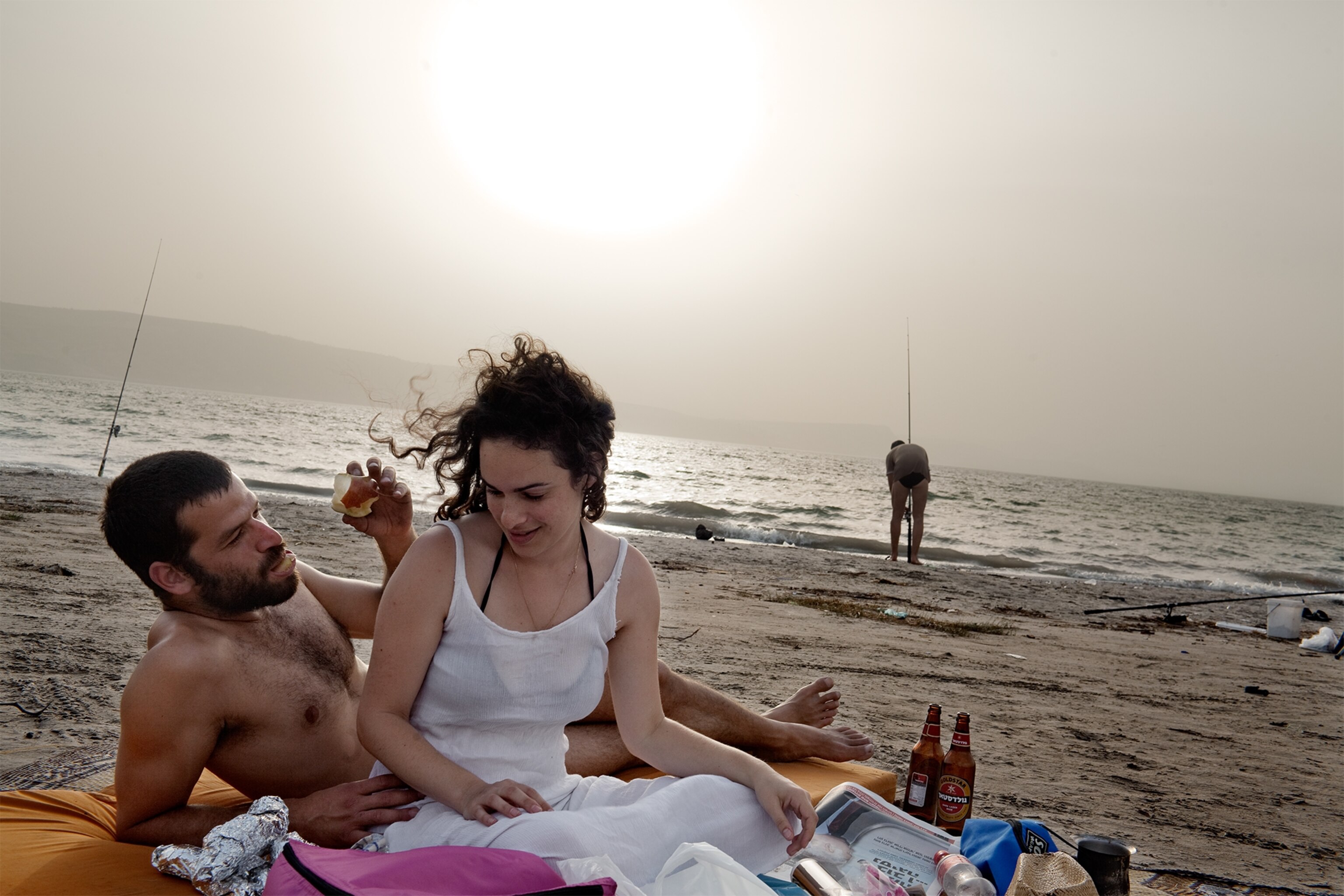 Israelis relaxing by the Sea of Galilee, which is fed by the Jordan River.
