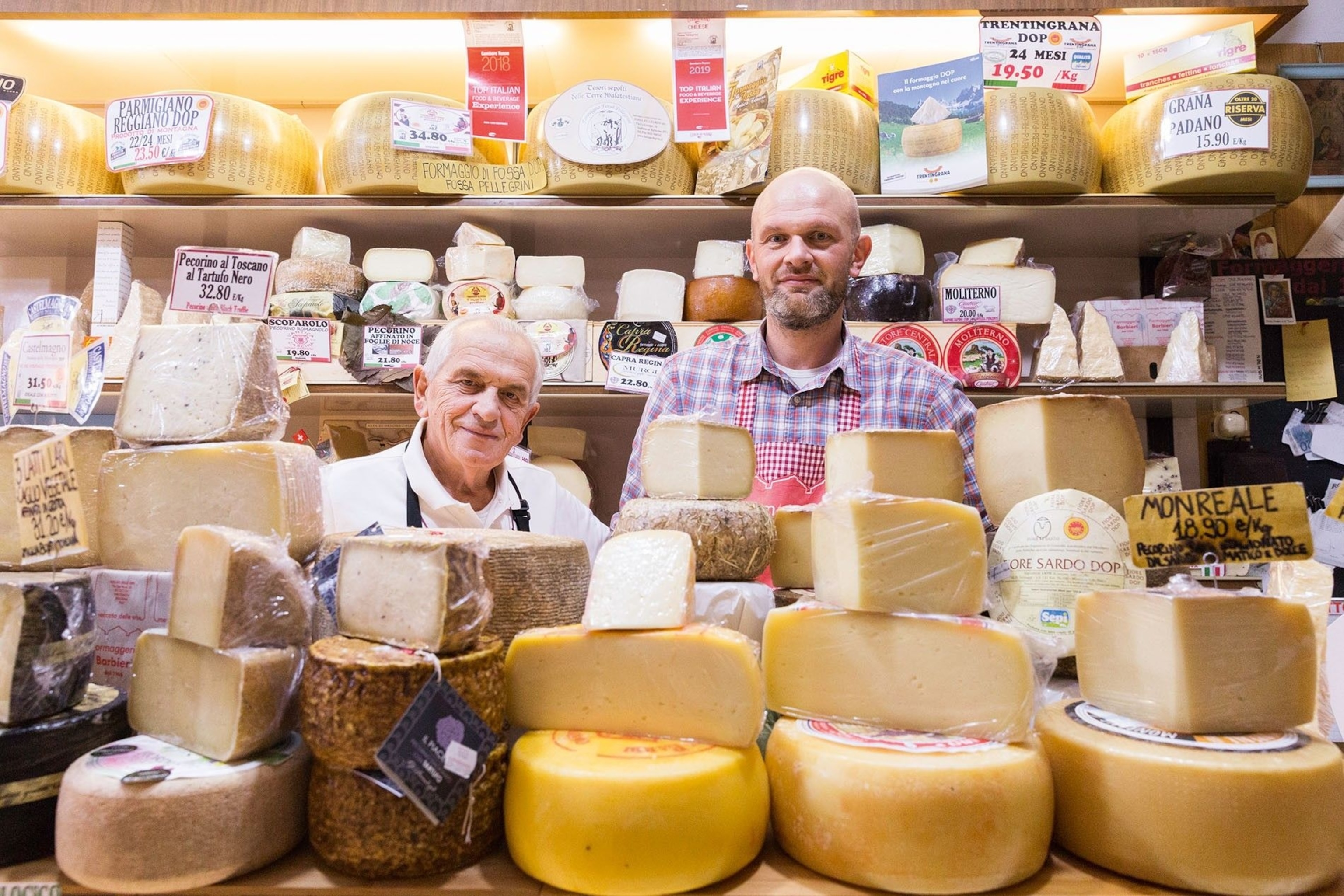 Father and son owners greet regular customers at Formaggeria Barbieri in Mercato delle Erbe.