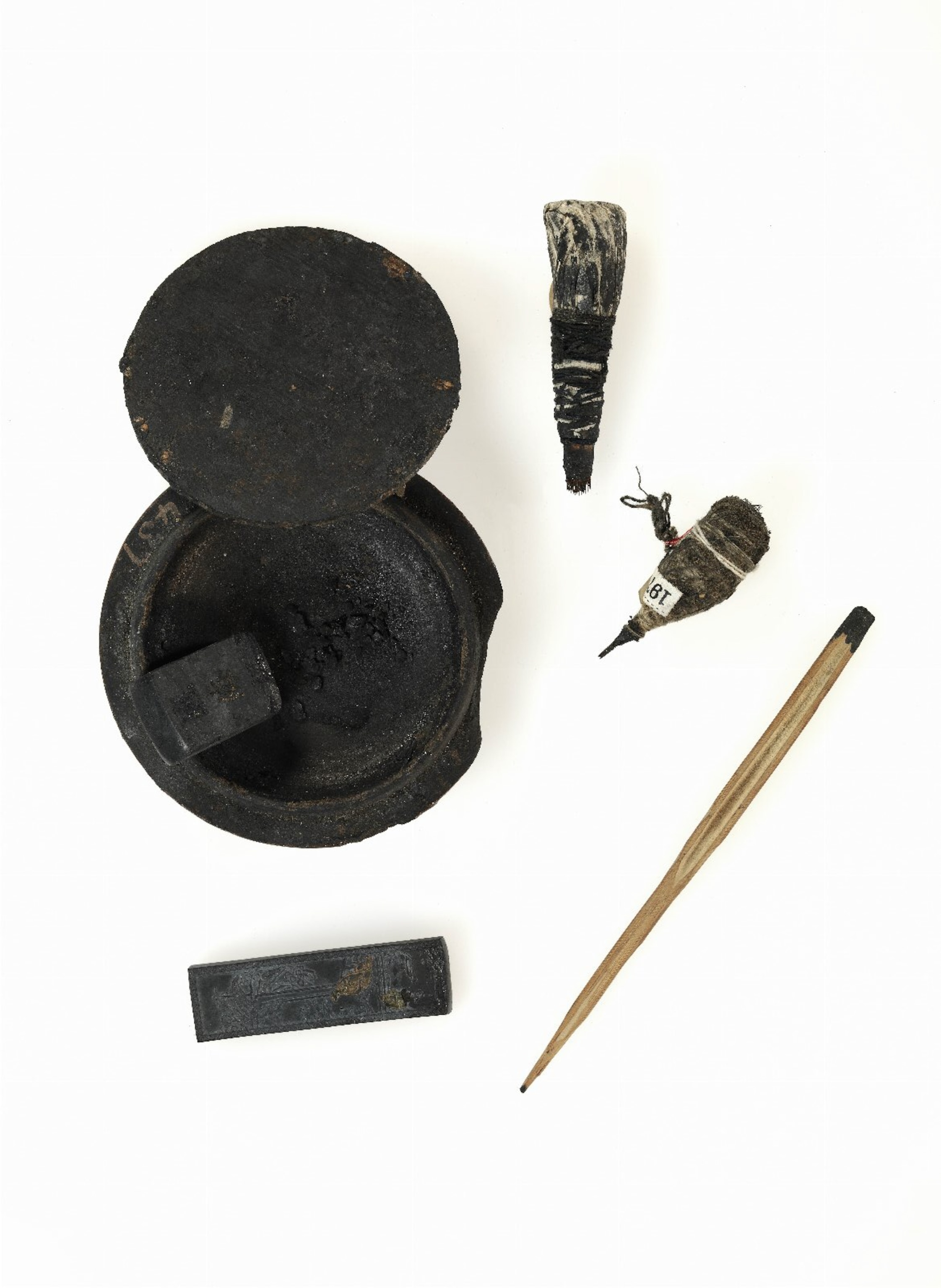 Ryukyuan Hajichi supplies, including a needle made from sharpened bamboo and a mortar for mixing ink.