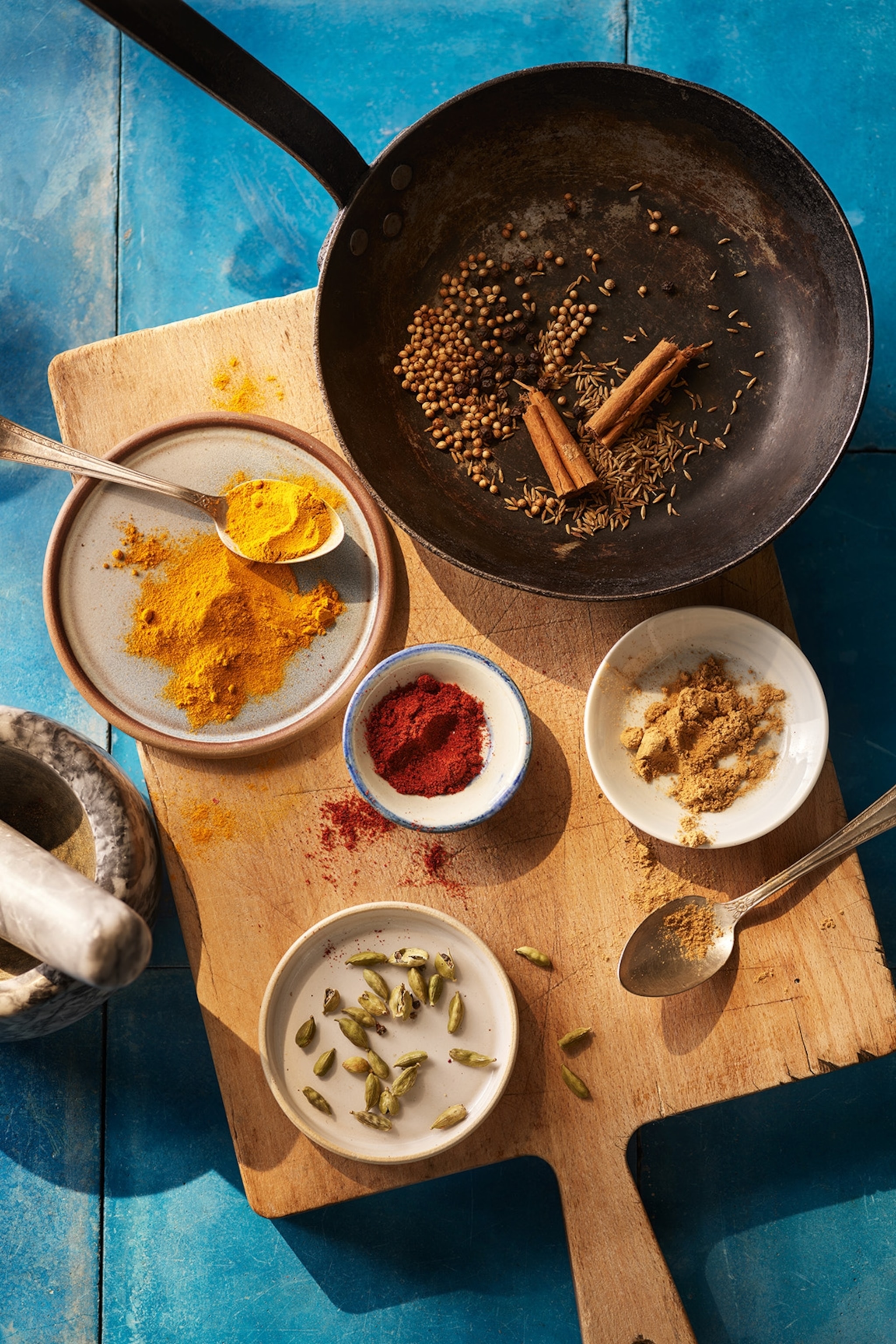Ingredients to make curry powder laid on a cutting board