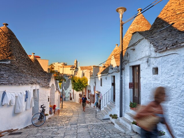 <p><strong>Where Old Ways Still Rule</strong></p><p class="p1">Greeks and Goths, Romans and Normans, Byzantines and Venetians: All put their feet, and flags, in the heel of Italy’s boot. There, the region of Puglia stretches a strategic 250 miles along the Adriatic Sea (and 95 miles on the Ionian), making it a key connection between <a href="http://travel.nationalgeographic.com/travel/countries/italy-guide/">Italy</a> and Europe’s east.</p><p class="p2">Today’s conquerors? The handful of cruise lines, maybe, that recently have added Puglia’s capital of Bari, once dismissed as a den of drug dealers and pickpockets, to glamorous itineraries alongside Venice and Corfu. Or the Italians who come from the north, packing Puglia’s beach-lined Salento peninsula each July and August.</p><p class="p2">But few visit Puglia beyond its most famous seaside towns, fewer still outside of the warm months. And—as proud as they are of their region’s ancient vineyards and medieval castles, cone-roofed trulli dwellings and white-sand beaches—many locals seem surprised by tourists’ attention. “If you go to Tuscany nowadays, you have to know where to go and what to do to have an off-the-beaten-path experience,” says Antonello Losito, a Bari native and the owner of tour company <a href="http://www.southernvisionstravel.com/" target="_blank">Southern Visions Travel</a>. “But Puglia is always off the beaten path.” By the time the sun sets on even the busiest summer day in Bari, cruise passengers have fled back to their buffets, and locals swell the town’s narrow streets and cobblestoned piazzas in their stead. Old men clutching canes chat in the distinctive local dialect. The scent of ragù floats through open doorways, blocked from the street only by hanging blankets. Families push strollers. Laundry flaps from windows.</p><p class="p2">Will Puglia change? Probably, someday. But not yet. For now, Puglia boasts the best of southern Italy: the pace, the traditions, the beauty. Unconquered. <em>—Amanda Ruggeri</em></p><p class="p2"><em><strong>Travel Tips </strong></em></p><p class="p2"><strong>When to Go:</strong> Visit in October or November, when summer tourists are long gone and the olive harvest is in full swing. Celebrate Carnival season in Putignano, which hosts one of Europe’s oldest and longest pre-Lenten festivals (dating back to 1394 and beginning each year on December 26).</p><p class="p2"><strong> How to Get Around:</strong> Fly into Bari or Brindisi. Once in Puglia, travel the region aboard the <a href="http://www.trenitalia.com/cms/v/index.jsp?vgnextoid=ad1ce14114bc9110VgnVCM10000080a3e90aRCRD" target="_blank">national</a> and <a href="http://www.fseonline.it/default.aspx" target="_blank">semiprivate</a> trains that run along the coast and into the interior.</p><p class="p2"><strong> Where to Stay:</strong> With its ancient tower and fortified whitewashed walls, upscale <a href="http://www.masseriatorrecoccaro.com/en/home/" target="_blank">Masseria Torre Coccaro</a> appears to be more fortress than farmhouse. Set among olive groves and almond trees, the seaside boutique hotel has 39 luxurious rooms and suites appointed with antiques. Breakfast is included, and there’s an onsite cooking school and a shuttle to the nearby beach club (and the hotel’s private yacht). Tower suites have the best Adriatic Sea views, and the Orange Grove Suite (a whitewashed hideaway built inside an ancient cave) with outdoor private terrace and pool is the most secluded.</p><p class="p2"><strong> Where to Eat or Drink:</strong> Pizzeria Enzo e Ciro is a no-frills Bari favorite for its thin-crust pies baked in a traditional wood-fired oven. Eat in (if tables aren’t available, there’s a stand-up counter at the back of the restaurant) or take out a whole classic pizza topped with buffalo mozzarella, tomato, and basil. Or choose from a lengthy list of topping options, including Nutella, bacon, and housemade <em>stracciatella</em>, Puglia’s own rich and tangy cheese made from strands of mozzarella soaked in heavy cream.</p><p class="p2"><strong>What to Buy:</strong> Shop for traditional Salentine crafts—<em>cartapesta</em> (papier-mâché) figurines, marsh-reed baskets, Leccese stone carvings, and wrought-iron candlesticks—at the city-run <a href="http://www.mostrartigianato.le.it" target="_blank">Mostra Permanente dell'Artigianato Salentino</a> (Consortium of Craftsman of Lecce) in Lecce and at <a href="http://www.terrarossasalento.it" target="_blank">Terrarossa</a> in Nardò.</p><p class="p2"><strong>Cultural Tip:</strong> When in doubt, smile and say <em>prego</em>. The multitasking word has multiple meanings, including “You’re welcome,” in response to <em>grazie</em>; “You're welcome to” or “Please do,” as an invitation to do something; “Can I help you?” or “What would you like to order?”; and “Go ahead” or “Help yourself.”</p><p class="p2"><strong> What to Read or Watch Before You Go:</strong> While not set in Puglia, E.M. Forster’s  <a href="http://www.amazon.com/Room-View-Penguin-Twentieth-Century-Classics/dp/0141183292/ref=pd_sim_sbs_b_1" target="_blank"><em>Room With a View</em></a> and Giuseppe di Lampedusa’s <a href="http://www.amazon.com/Leopard-Novel-Giuseppe-Di-Lampedusa/dp/0375714790" target="_blank"><em>Leopard</em></a> are timeless introductions to Italian life and culture.</p><p class="p2"><strong> Helpful Link: </strong><a href="http://www.viaggiareinpuglia.it/hp/en" target="_blank">Puglia Tourism</a></p><p class="p2"><strong> Fun Fact:</strong> <a href="http://whc.unesco.org/en/list/787" target="_blank"> Alberobello</a> in southern Puglia is the city of fanciful trulli, which are clustered in a settlement dating back to the mid-14th century. The fairytale landscape, a UNESCO World Heritage site, includes several trulli restored as <a href="http://www.trulliholiday.com/Defaulteng.asp" target="_blank">vacation rentals</a>.</p><p class="p2"><strong> Insider Tip From Amanda Ruggeri:</strong> For the best of authentic Puglia, stay at a <em>masseria</em>, a working farmhouse that’s traditionally been fortified against attacks by pirates or Turks (a serious local issue until the 19th century!). Bonus: <em>Masserie</em> that are B&amp;Bs often also serve up home-cooked meals from their own produce.</p><p class="p2"><em style="font-family: Arial,sans-serif; font-size: 12px; line-height: 19px;"><a style="text-decoration: none;" href="http://www.nationalgeographicexpeditions.com/expeditions/amalfi-italy-tour/detail?utm_source=travel.nationalgeographic.com&amp;utm_medium=link&amp;utm_content=20131121-BOTW-SouthernItaly&amp;utm_campaign=NGdotcom" target="_blank">Explore the hidden gems of Puglia on a National Geographic Expedition to southern Italy.</a></em> >></p>