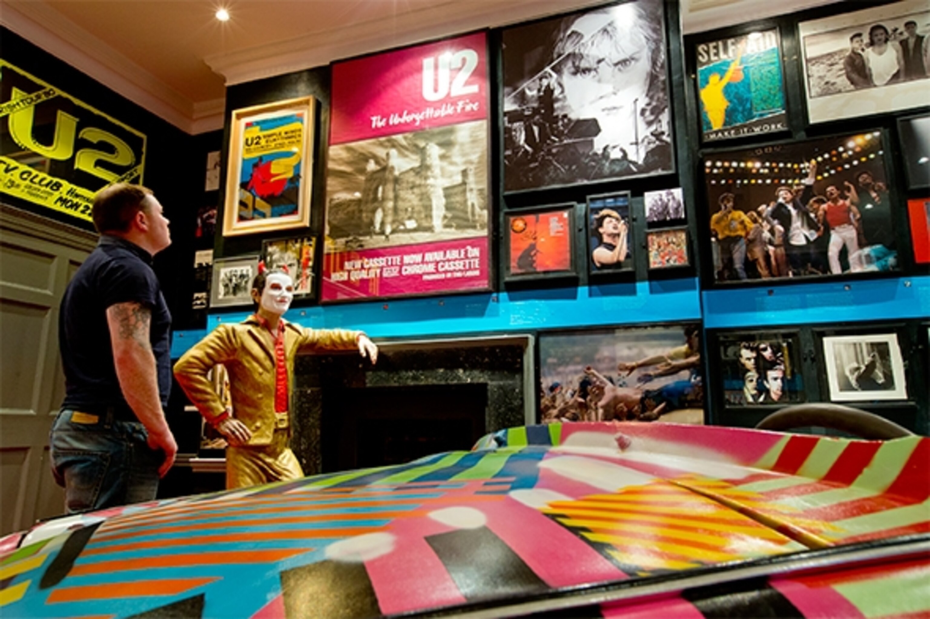 Leon Knight examines the displays in the U2 exhibit in Dublin's Little Museum. The exhibition is “very much a work in progress,” according to curator Simon O’Connor. “Fans are coming in with new items every day.” (Photograph by Catherine Karnow)