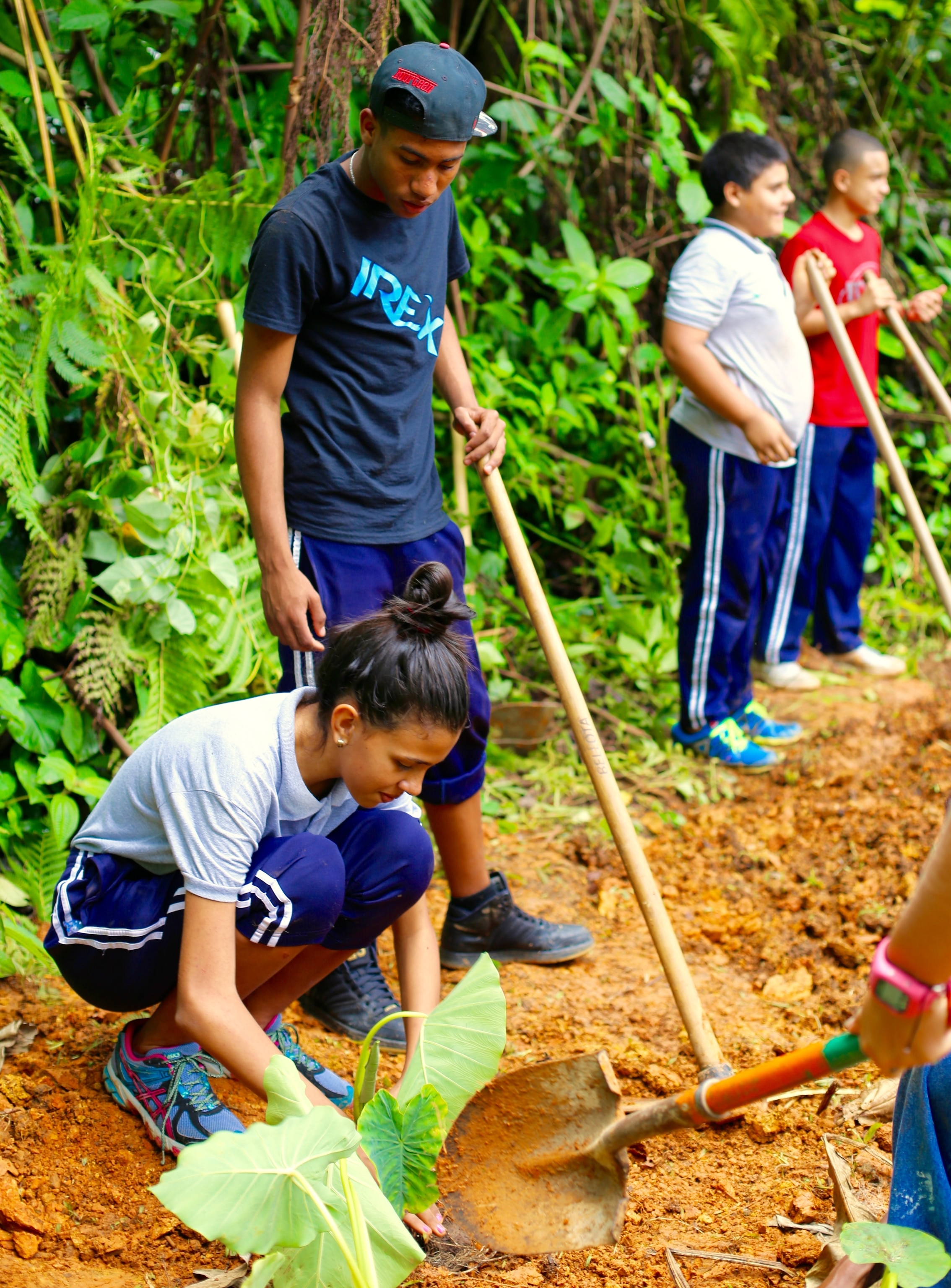 a student planting at plenitud farm
