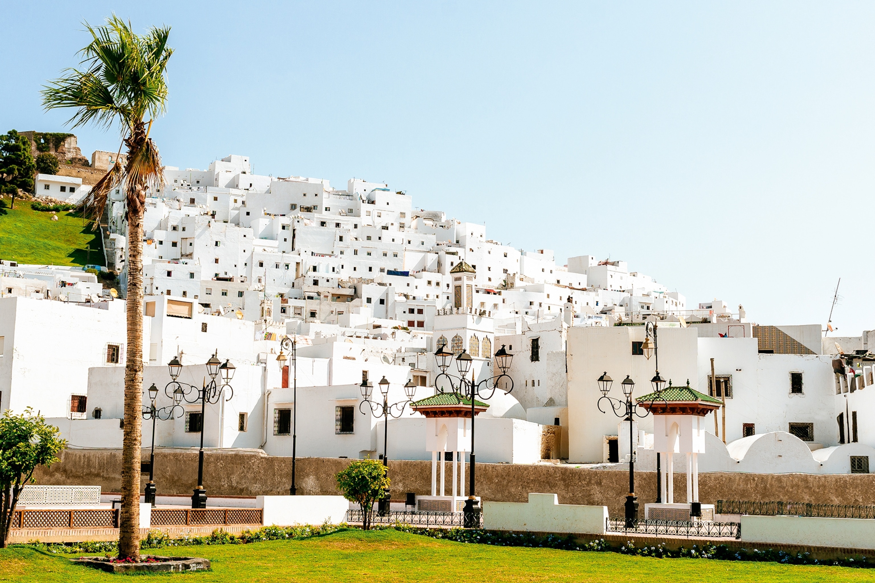A landscape view of a white-washed city on a hill in Morocco.