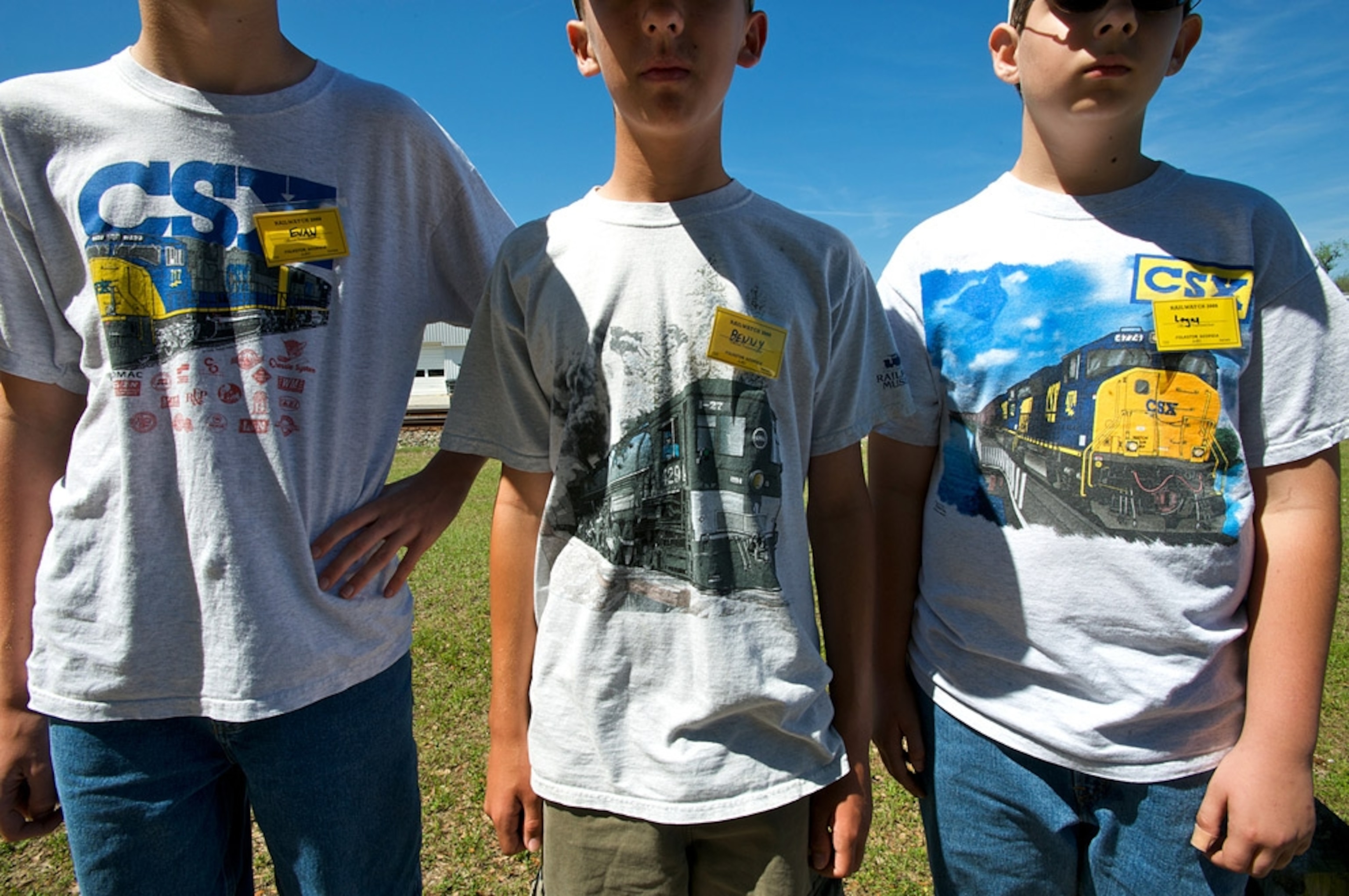 Close-up of three boys with train t-shirts