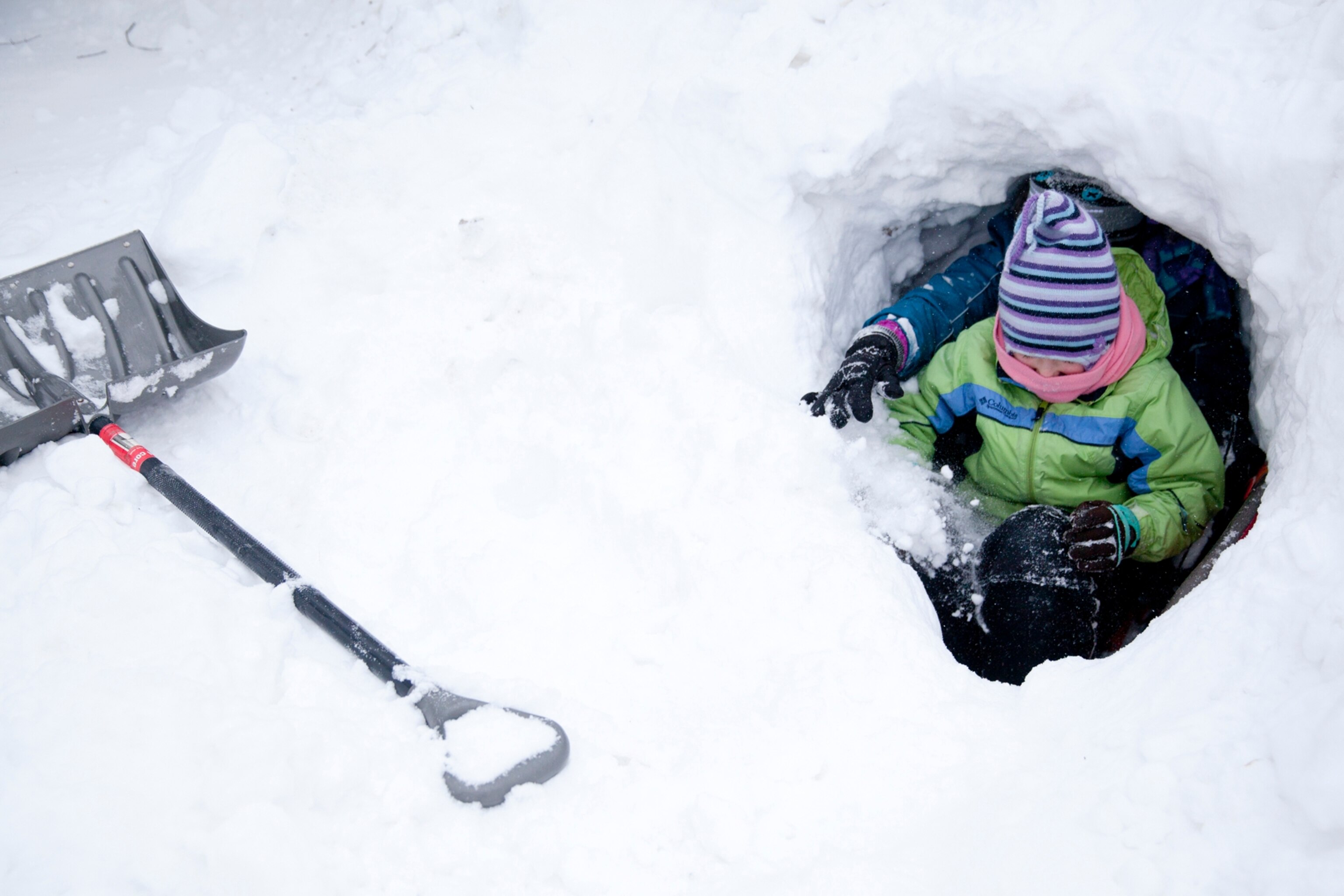 two children playing in snow.