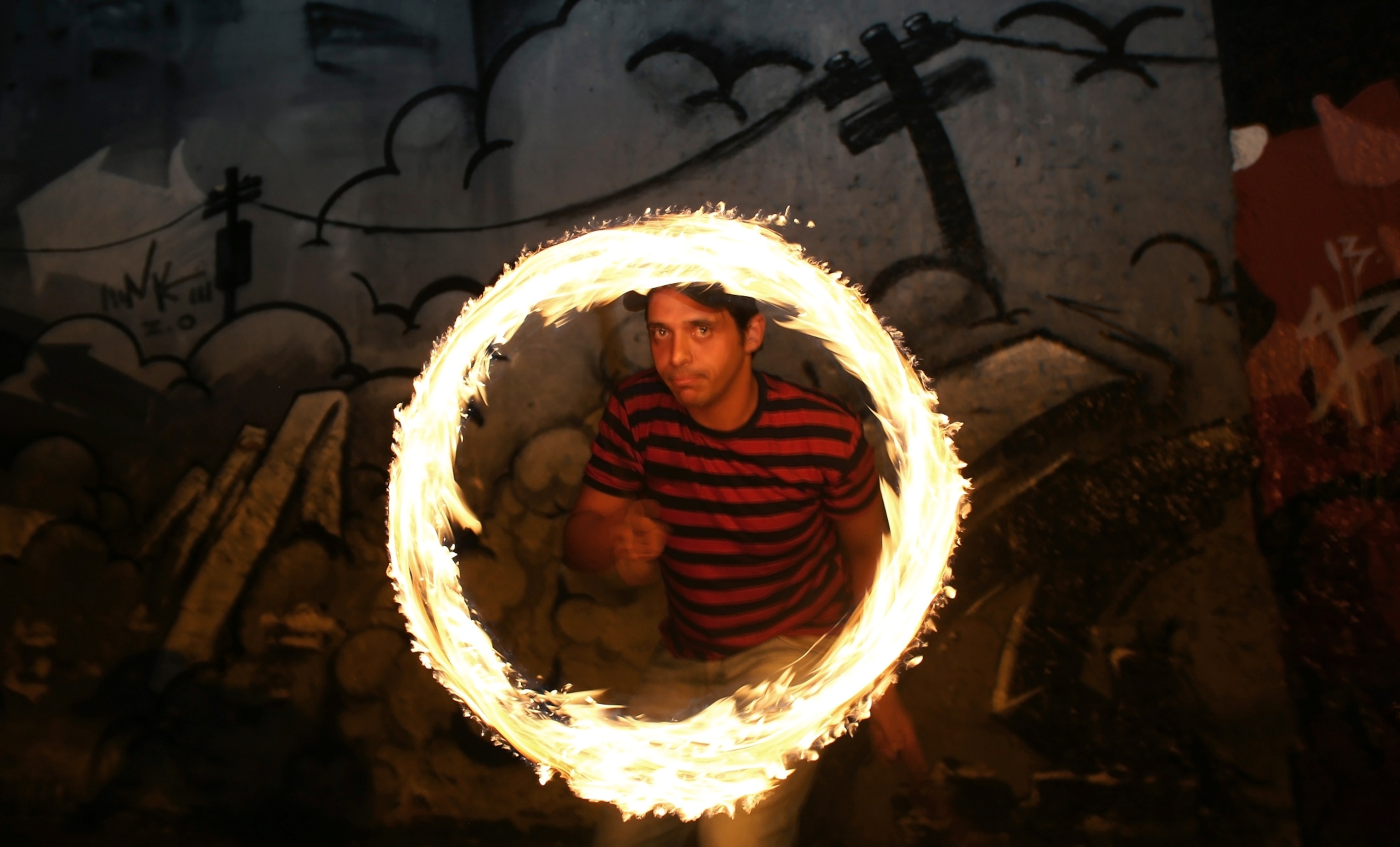Circus of the Alley - A picture of a juggler performing with flaming torches in São Paulo, Brazil