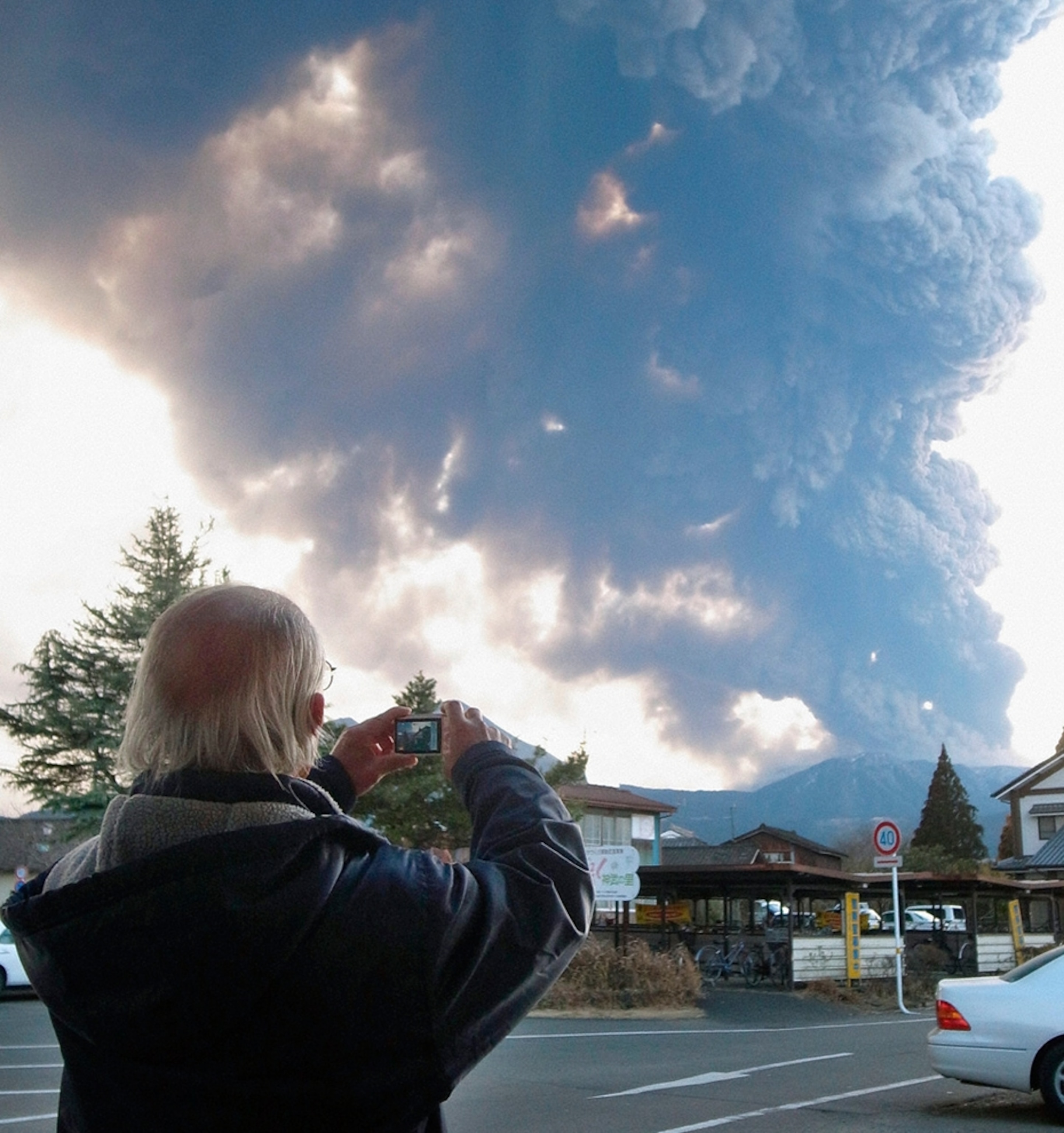 Kirishima volcano eruption picture: Man takes a picture of the Mount Kirishima eruption in Japan.