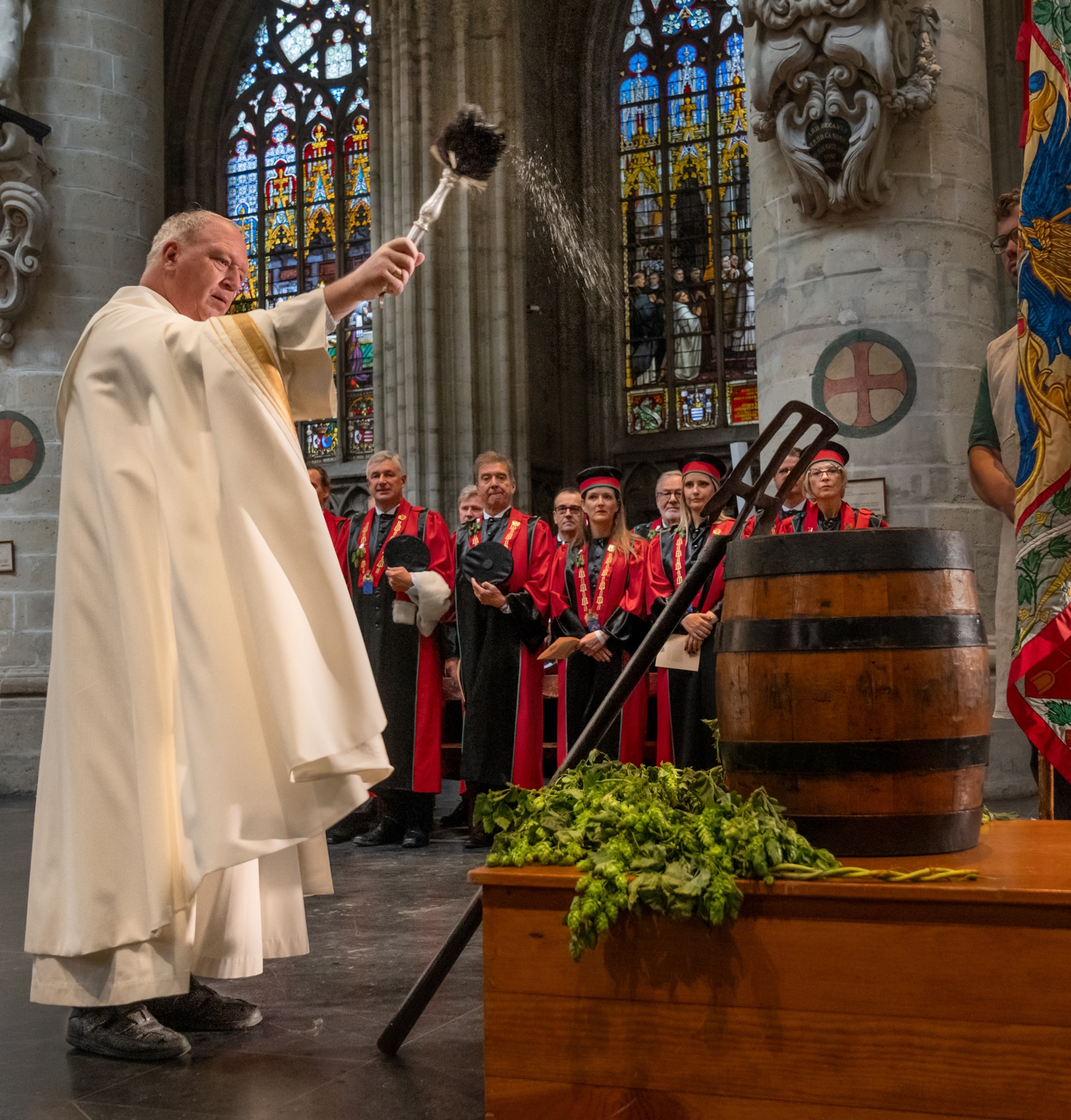Inside the Cathedral of St. Michael and St. Gudula, a priest blesses the barrel to commemorate the patron saint of beer, St. Arnold, an 11th-century bishop.