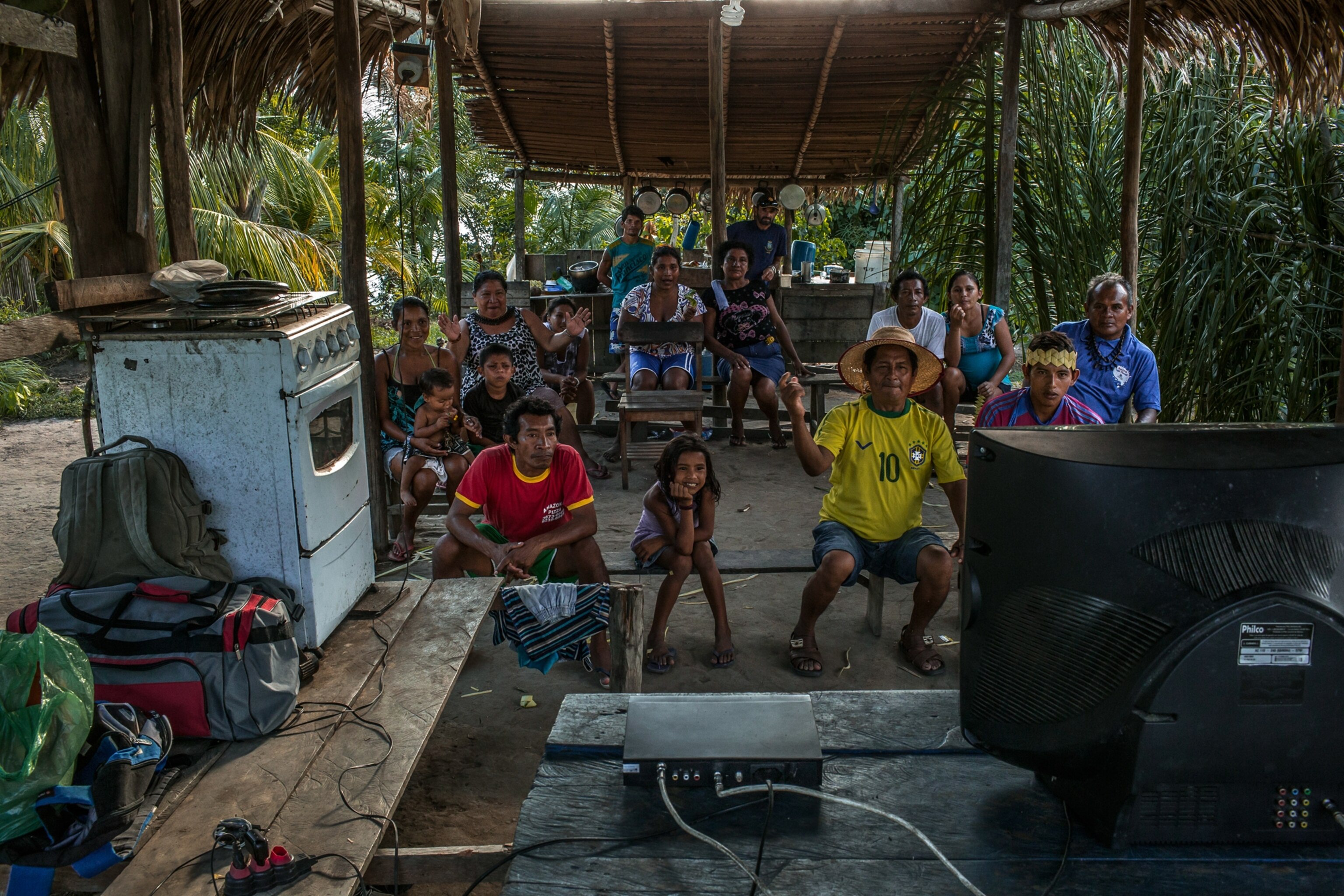 With a television cutting off repeatedly, villagers gather to watch Brazil play Mexico in the Amazonian village of Nova Belo Horizonte, Brazil.