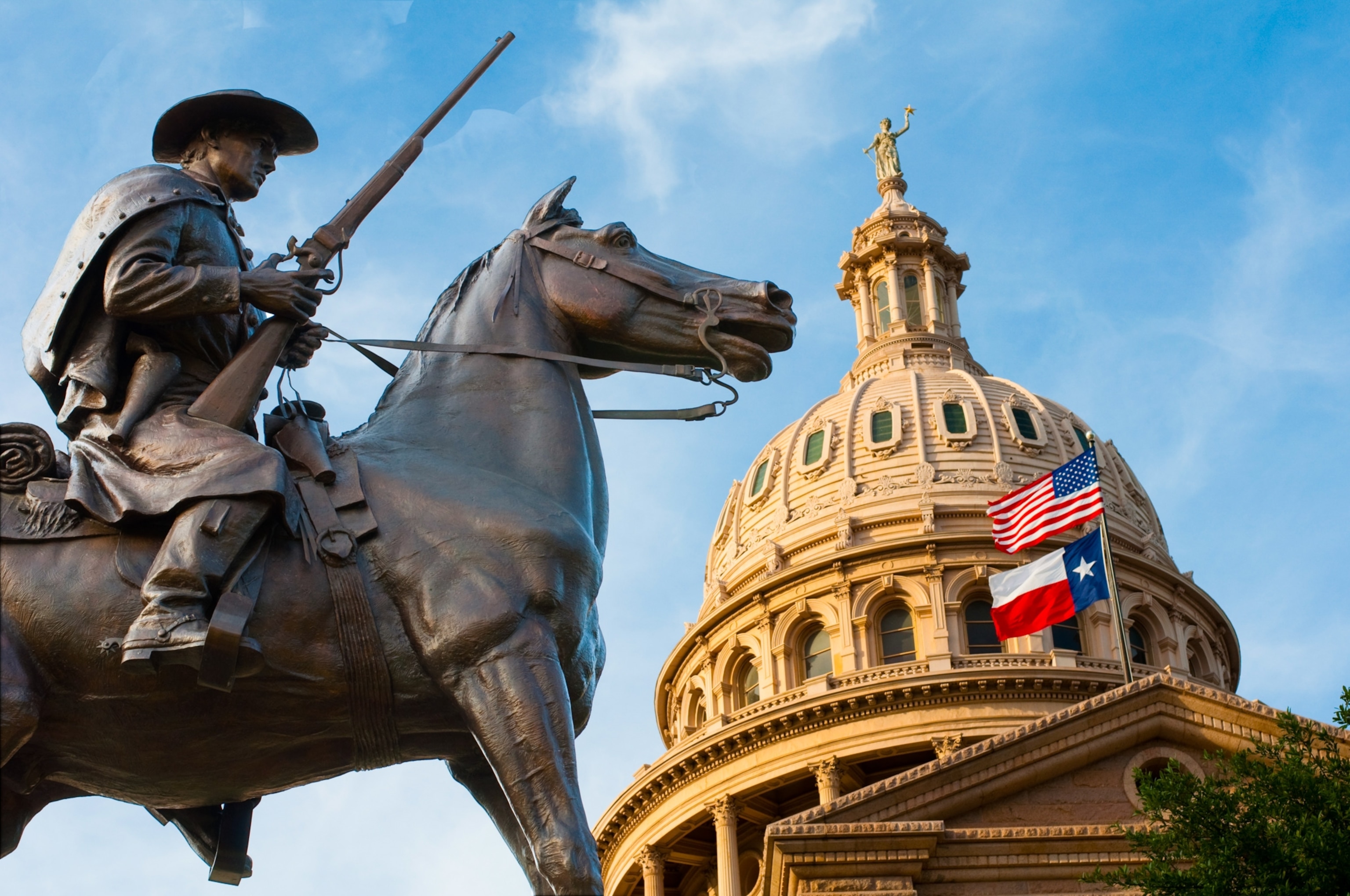 a ranger statue and capitol dome in Austin, Texas
