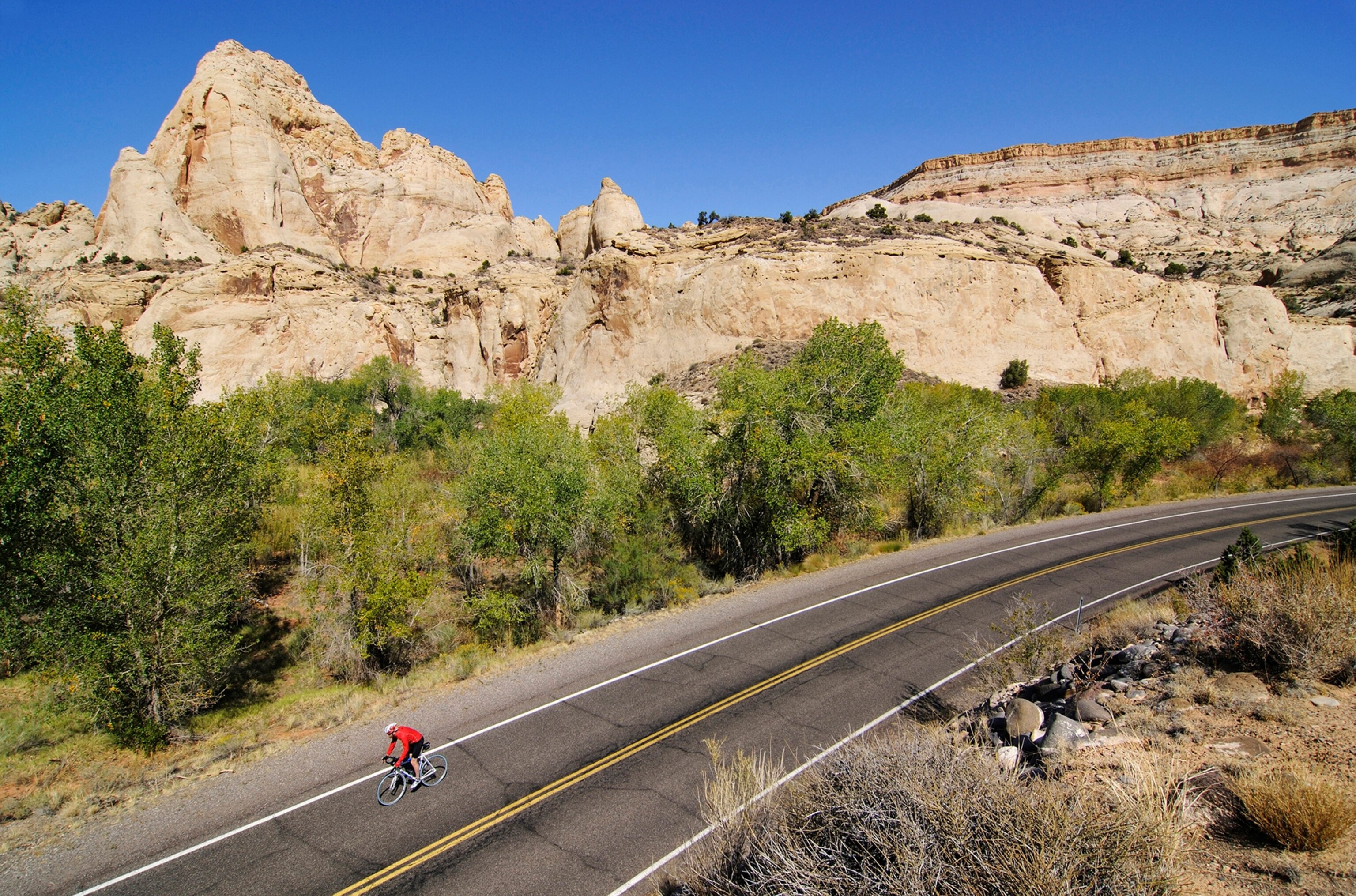a bicyclist on a road in Capitol Reef National Park, Utah