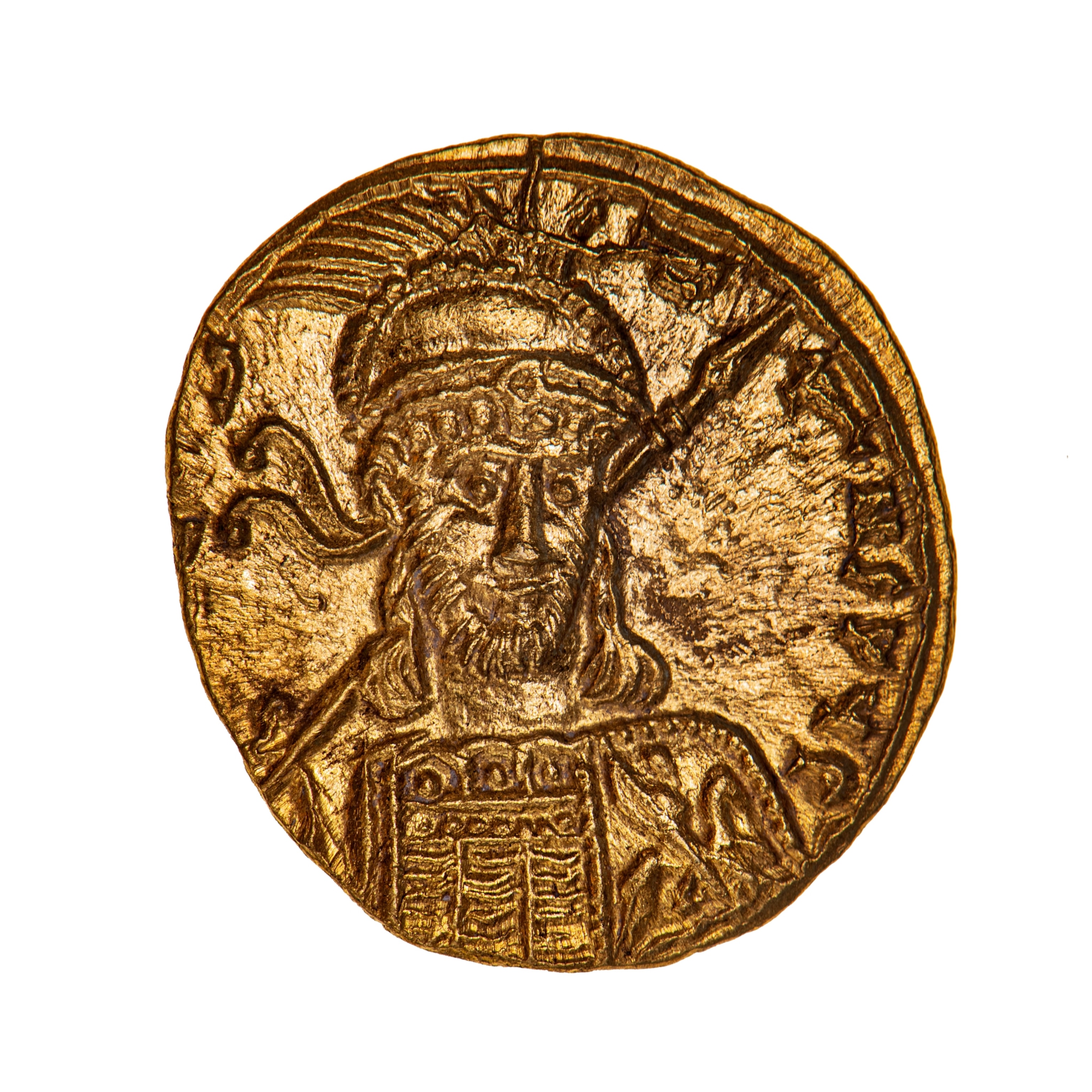A gold coin with a stamped image of a man in armor holding a spear.