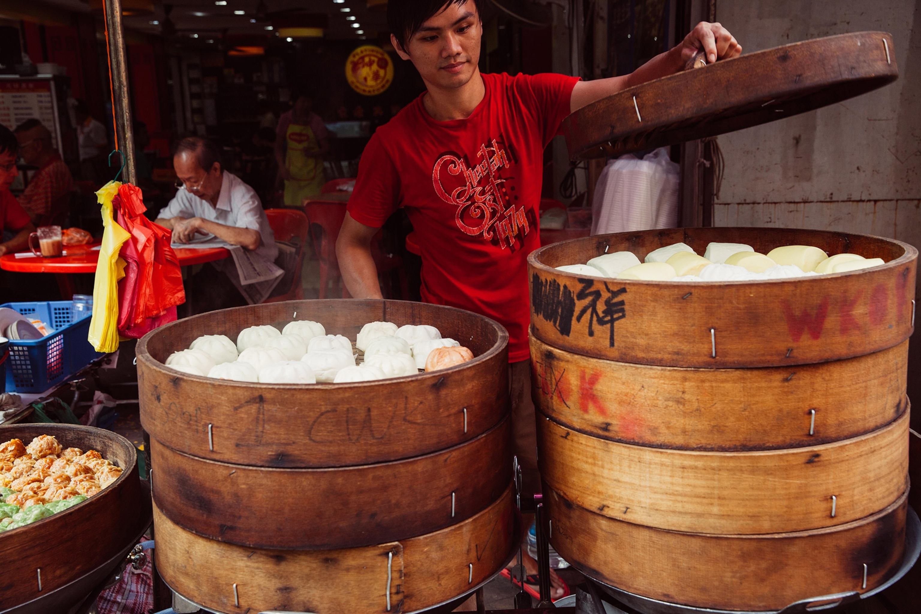 a man cooking Chinese traditional steamed buns in Chinatown, Kuala Lumpur, Malaysia