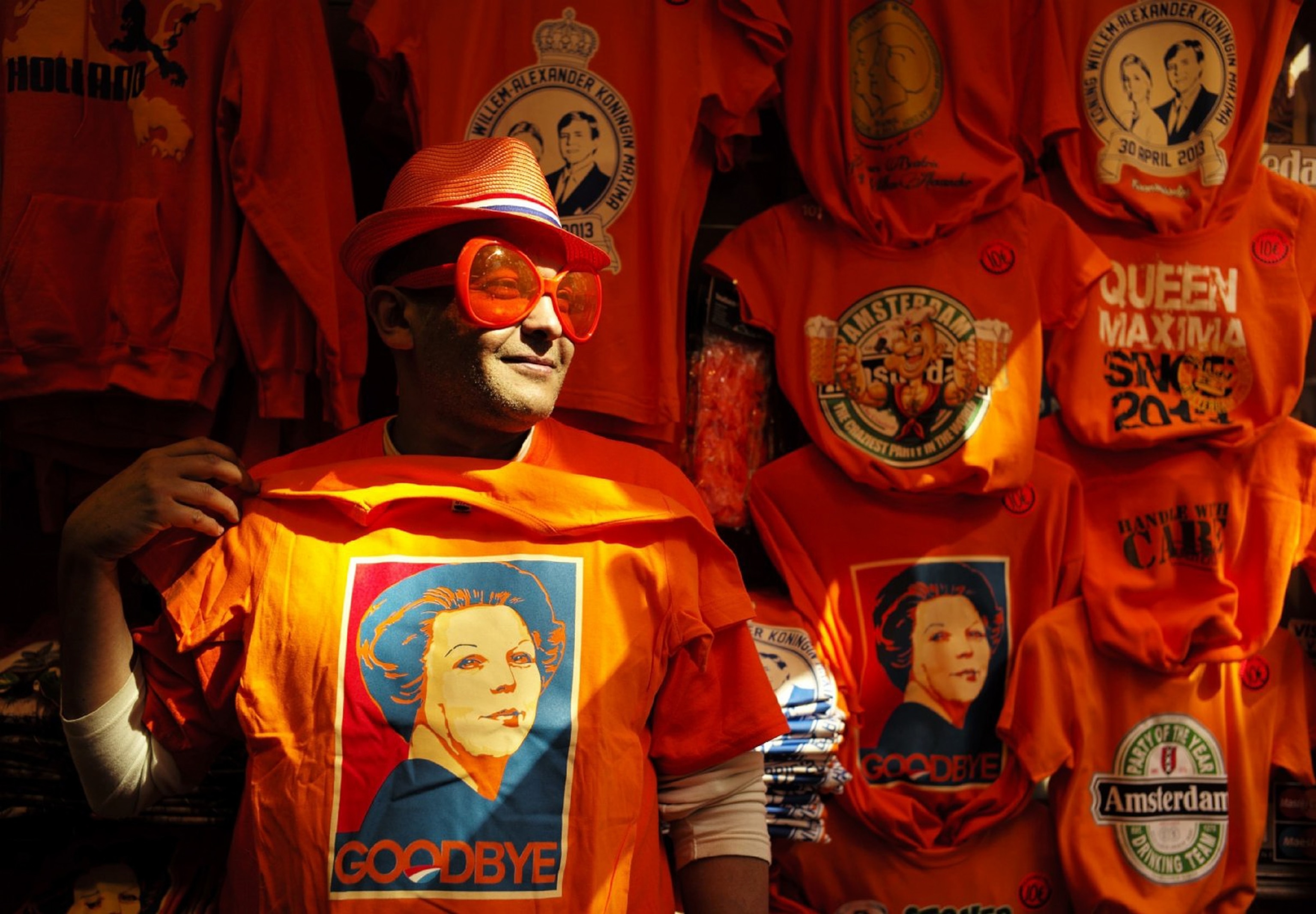 man holding an orange Queen Beatrix t-shirt in the Netherlands