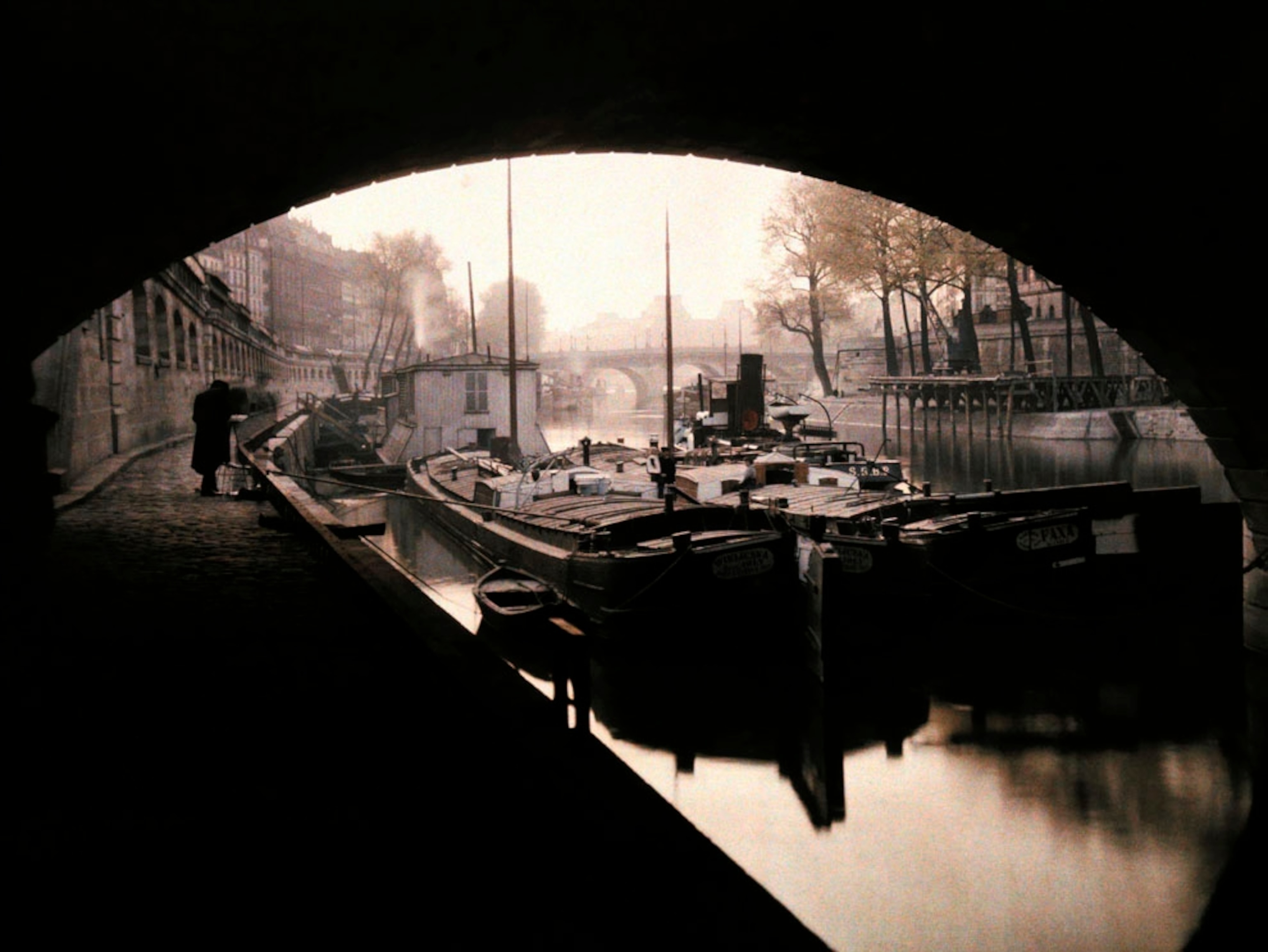 View of boats from beneath a bridge