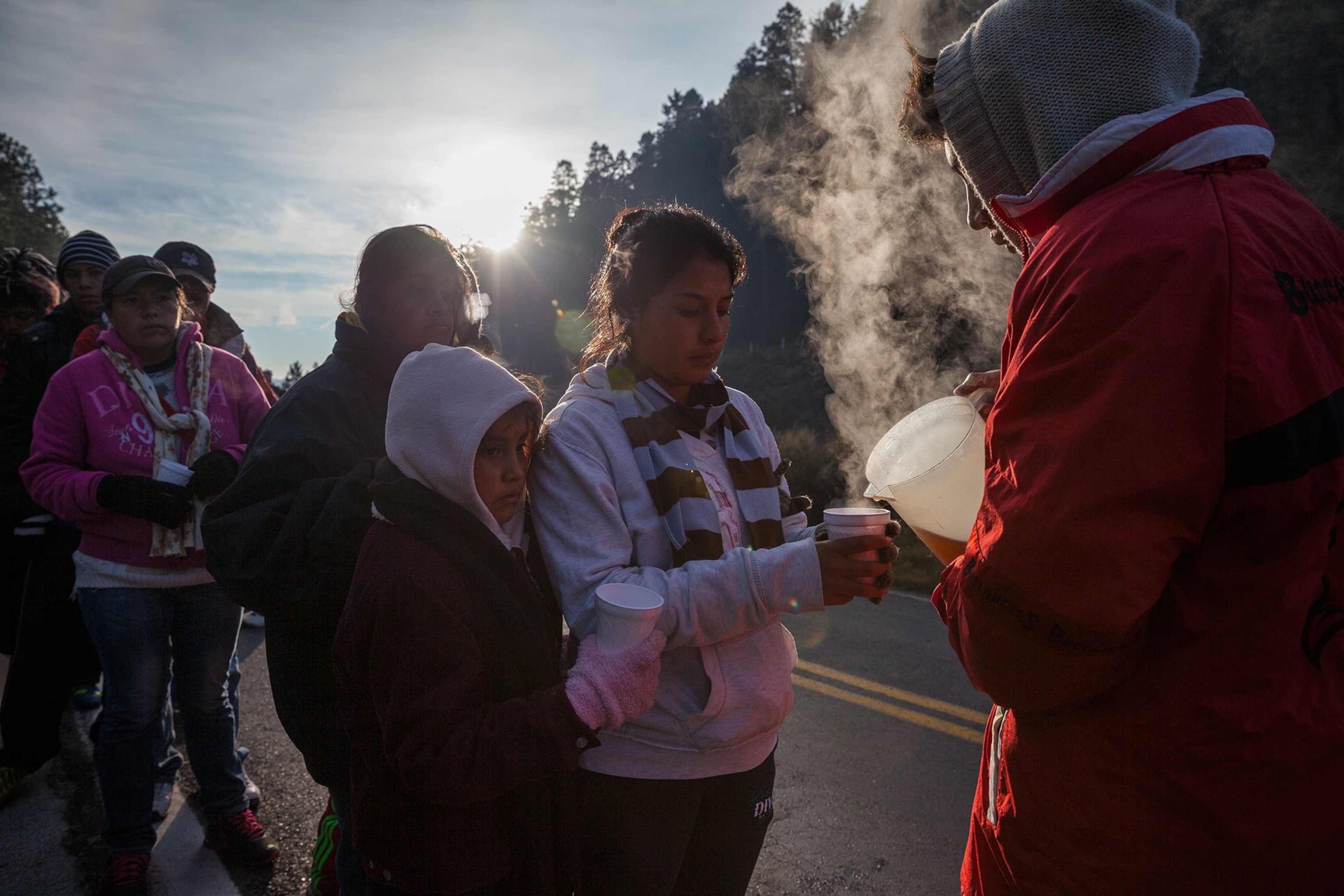 a man pouring a hot beverage.