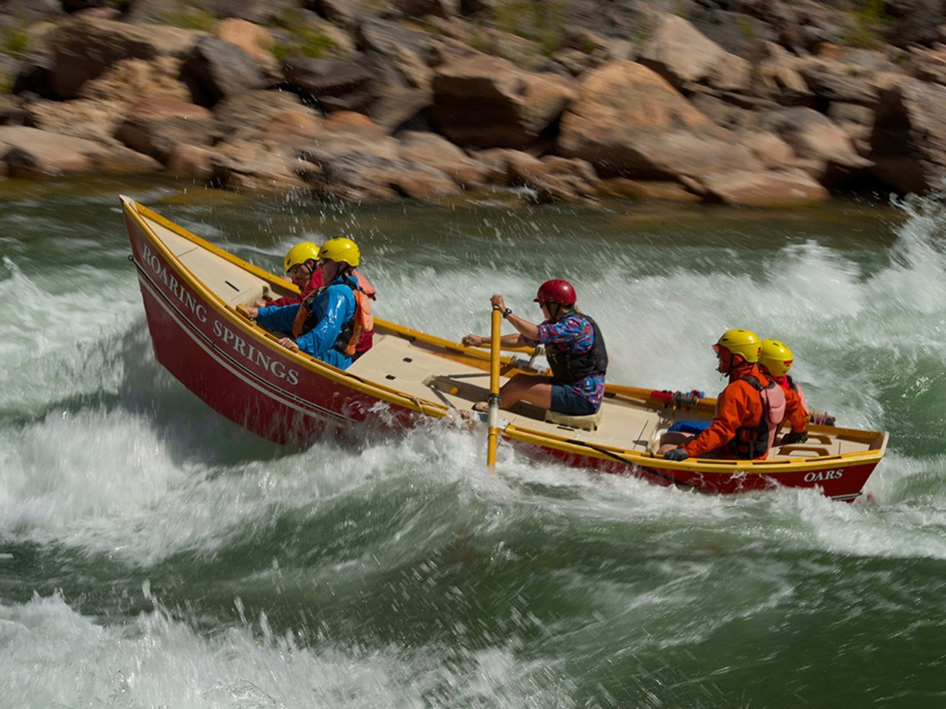 people in a dory on a river