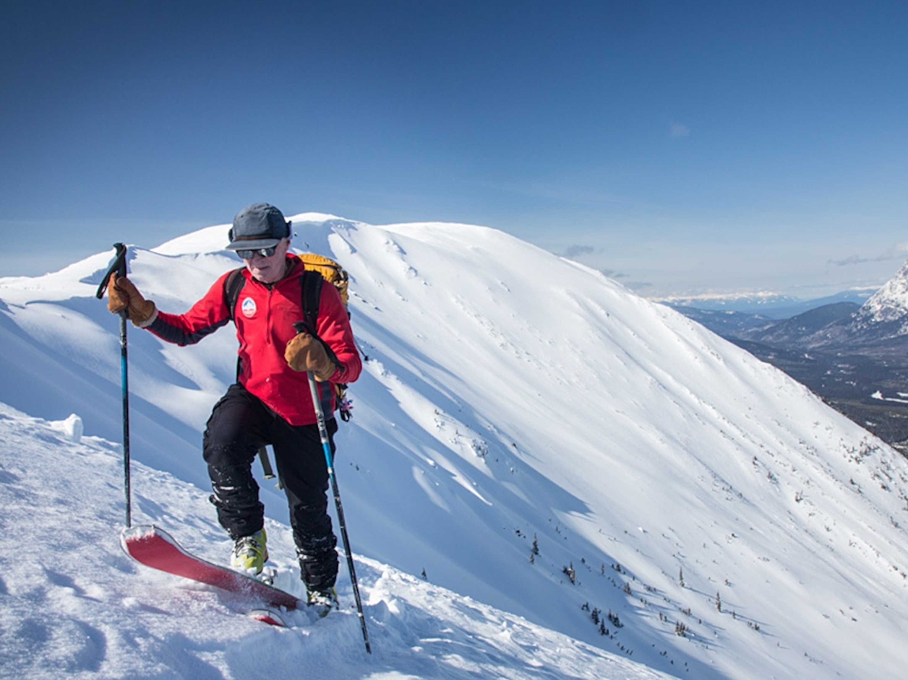 a man on skis climbing up the backcountry slopes of Hankin-Evelyn, British Columbia, Canada
