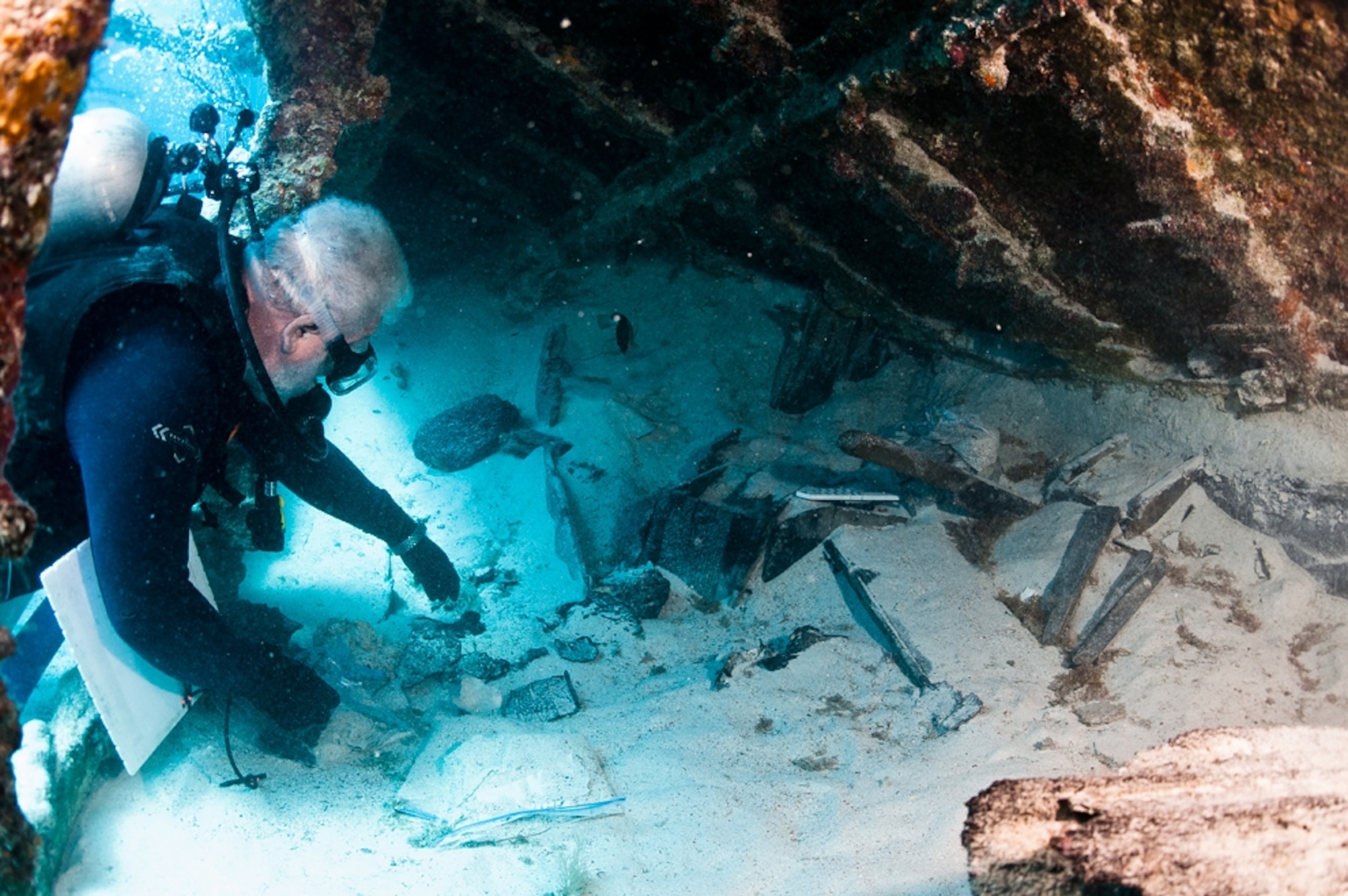 Shipwreck picture: an archaeologist recovering a paint can in the Civil War-era Mary Celestia shipwreck off Bermuda