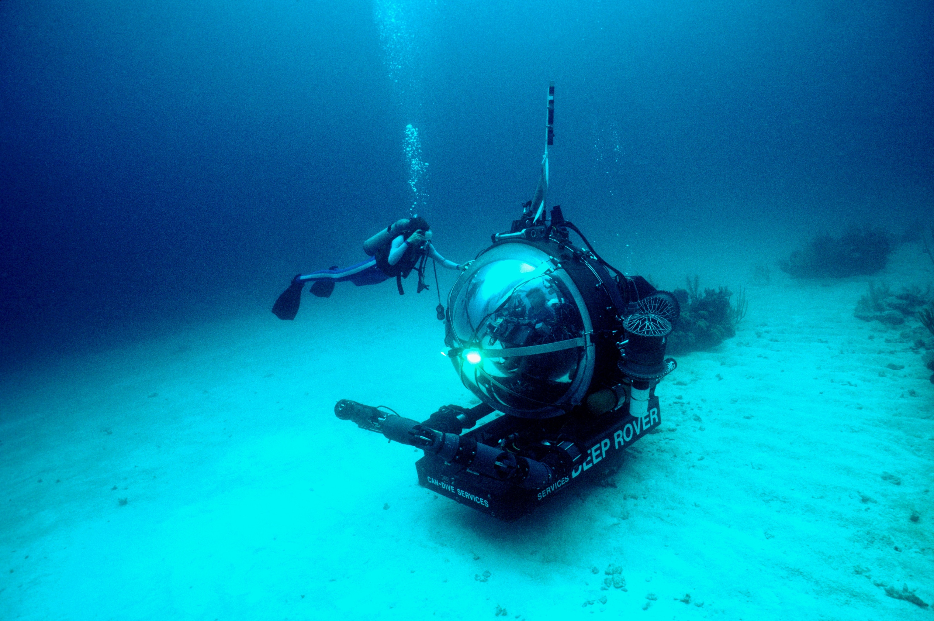 Dr. Sylvia Earle inspects the exterior of Deep Rover submersible as it descends on test dive.