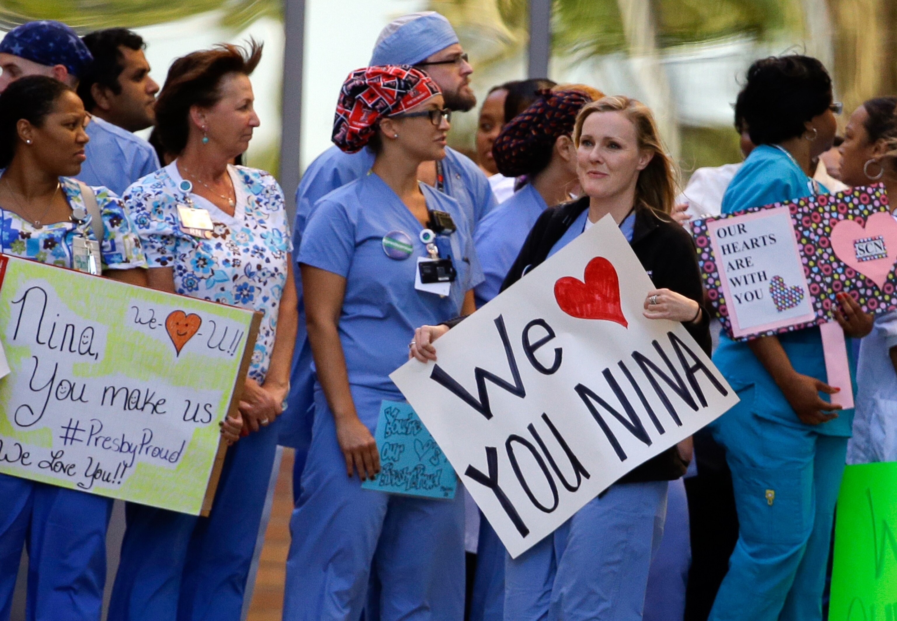 health workers taping the door of healthcare worker in Dallas.