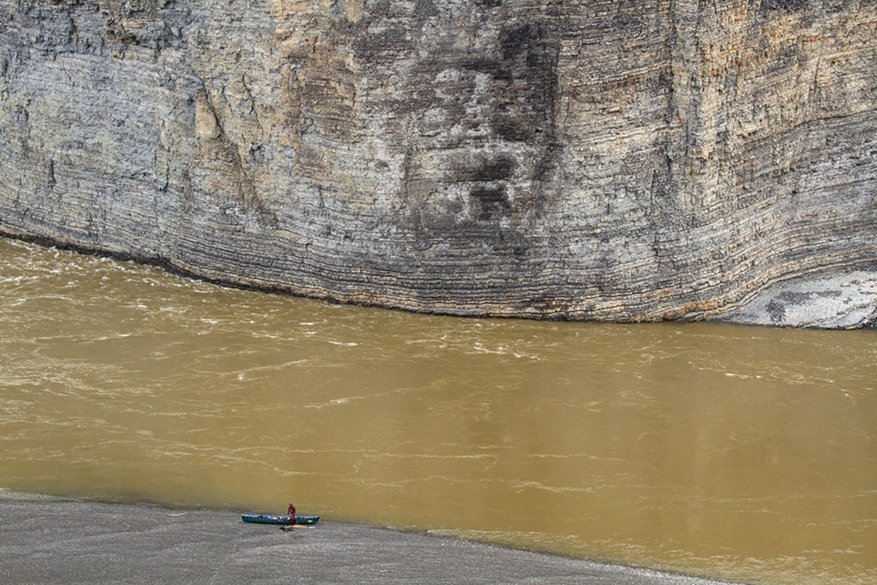 Amy Freeman packing a kayak, Aberdeen Canyon, Peel River, Yukon Territory, Canada