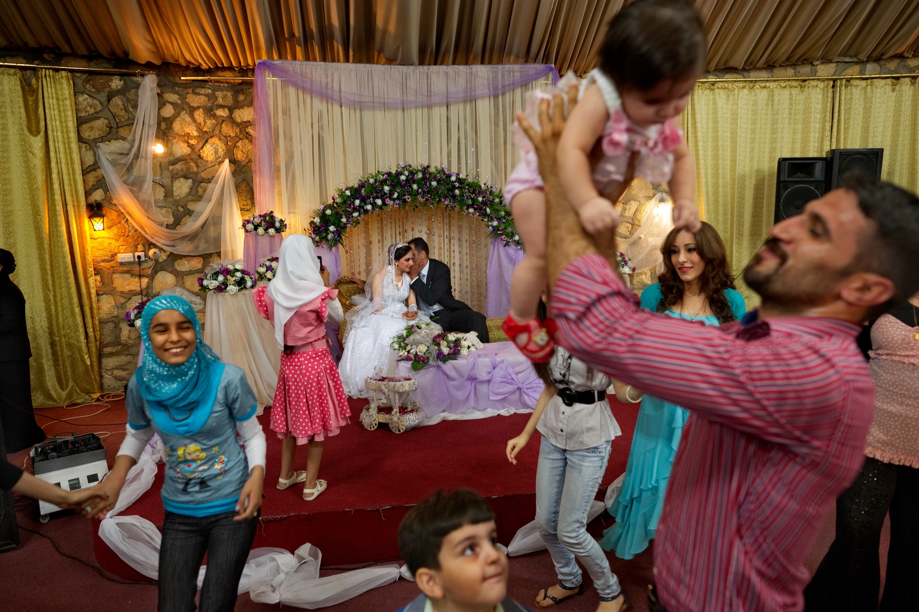 This image of a lavish wedding celebration, published in our July 2011 issue, depicted how life had changed for Iraqis in Baghdad years after war divided their city.