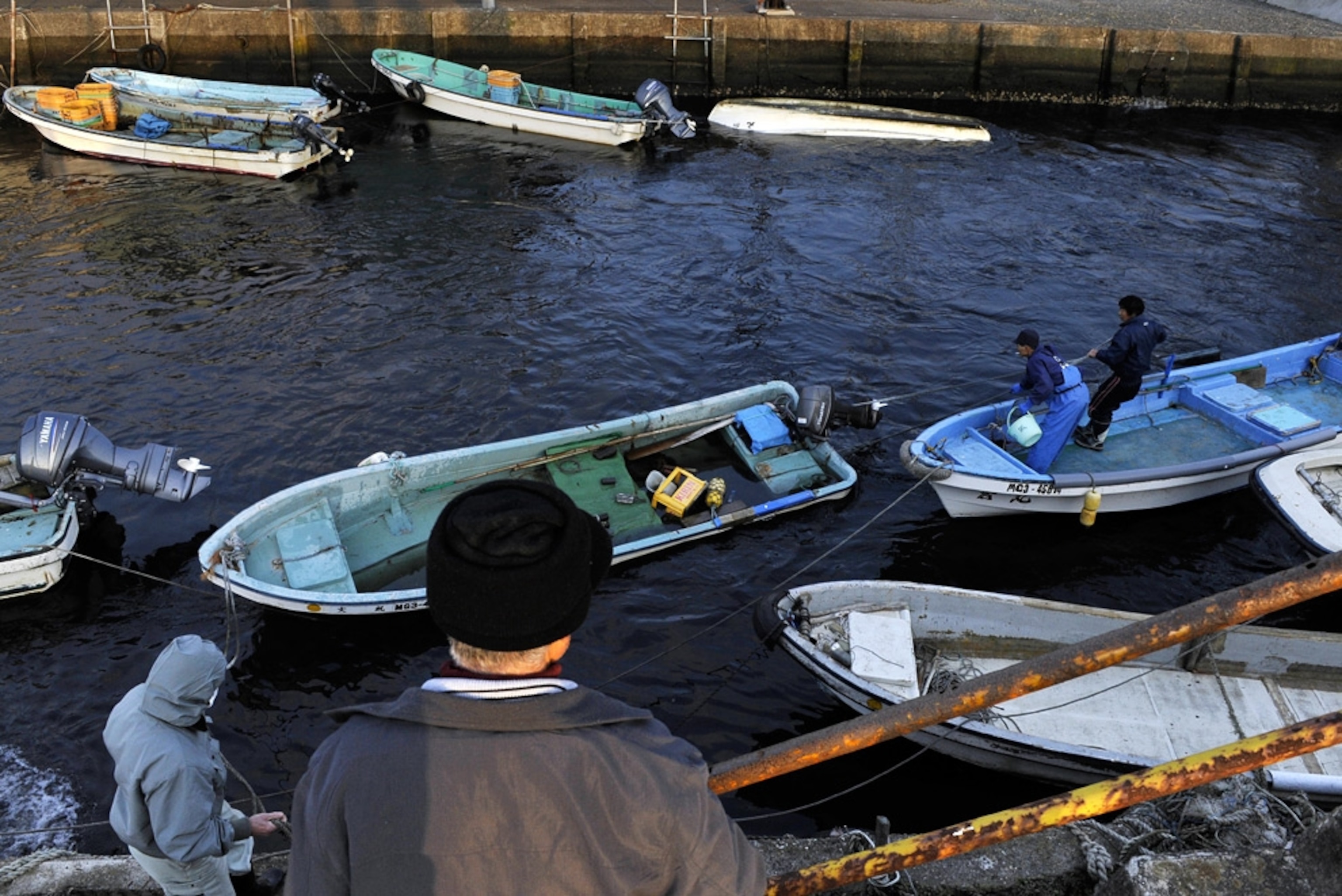 Fishermen recover their fishing boats in the Japanese port of Minami-sanriku, Miyagi Prefecture on February 28, 2010