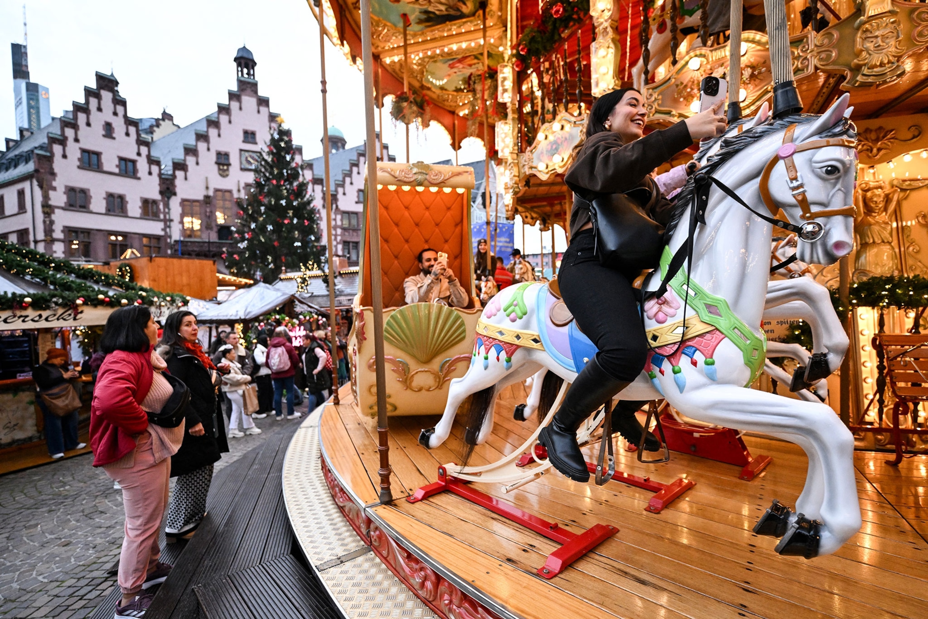 People visit just opening Christmas fair at the central Roemer Square in Frankfurt am Main, western Germany.