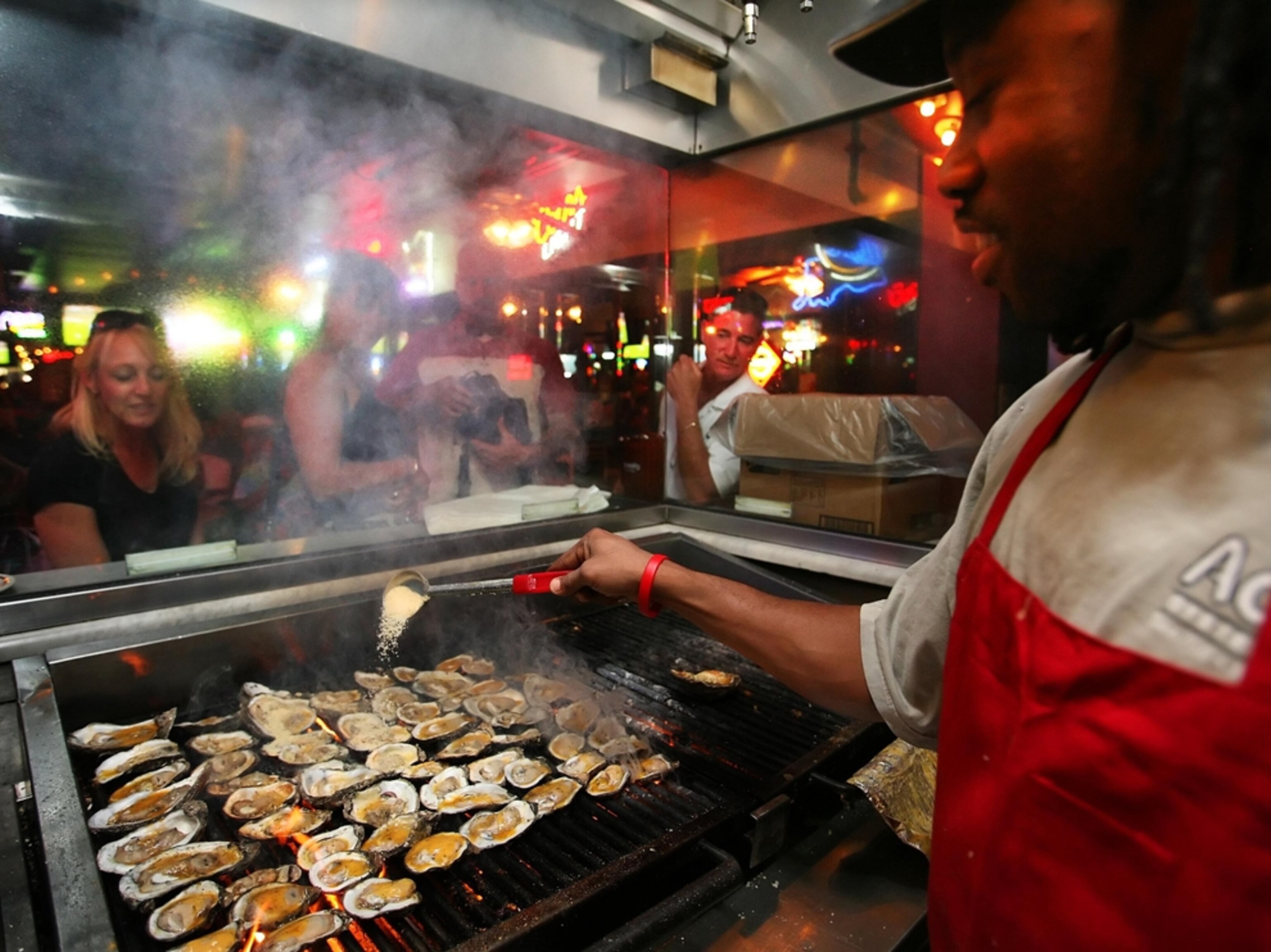 Charles Jackson grilling oysters at the Acme Oyster House in the French Quarter, New Orleans